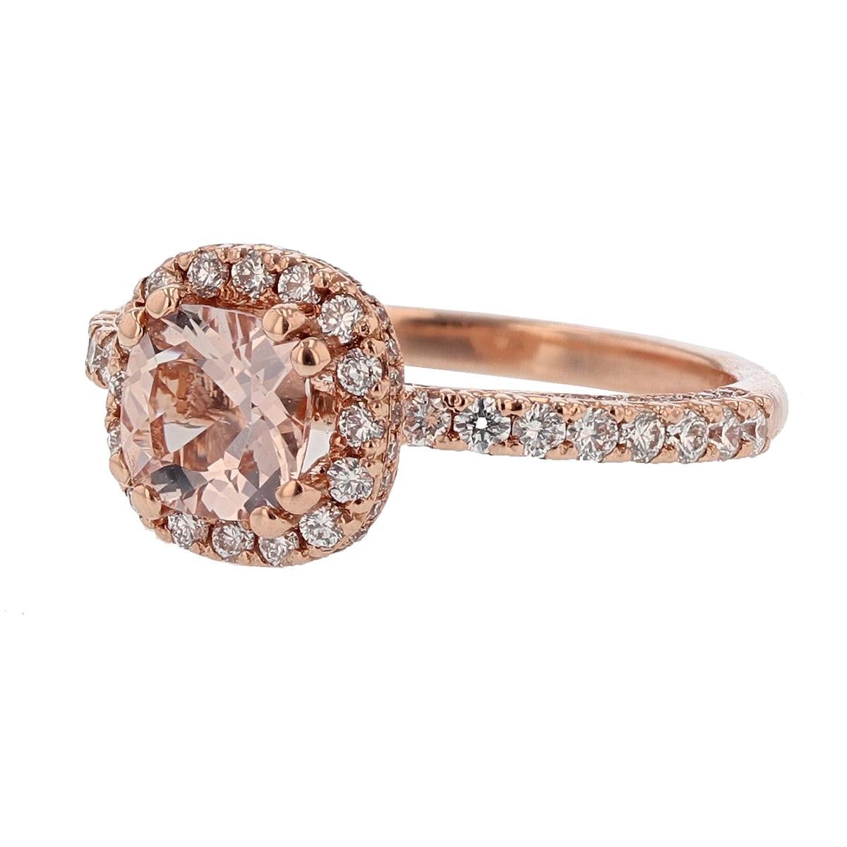 This ring is designed by Nazarelle and made in 14k rose gold. The center stone is a cushion shape morganite weighing 0.78ct and is prong set. The mounting features 0.67ct of round diamonds.