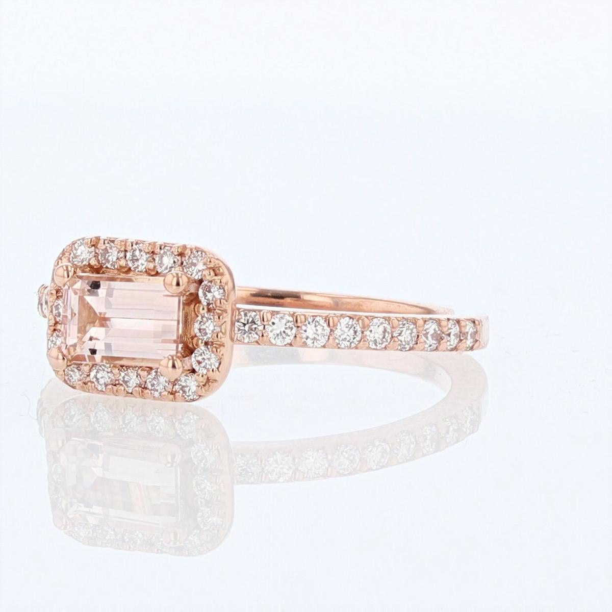 This ring is designed by Nazarelle and made in 14k rose gold. The center stone is an emerald cut Morganite set horizontally, weighing 0.54ct and is prong set. The mounting features 0.33ct of round diamonds.