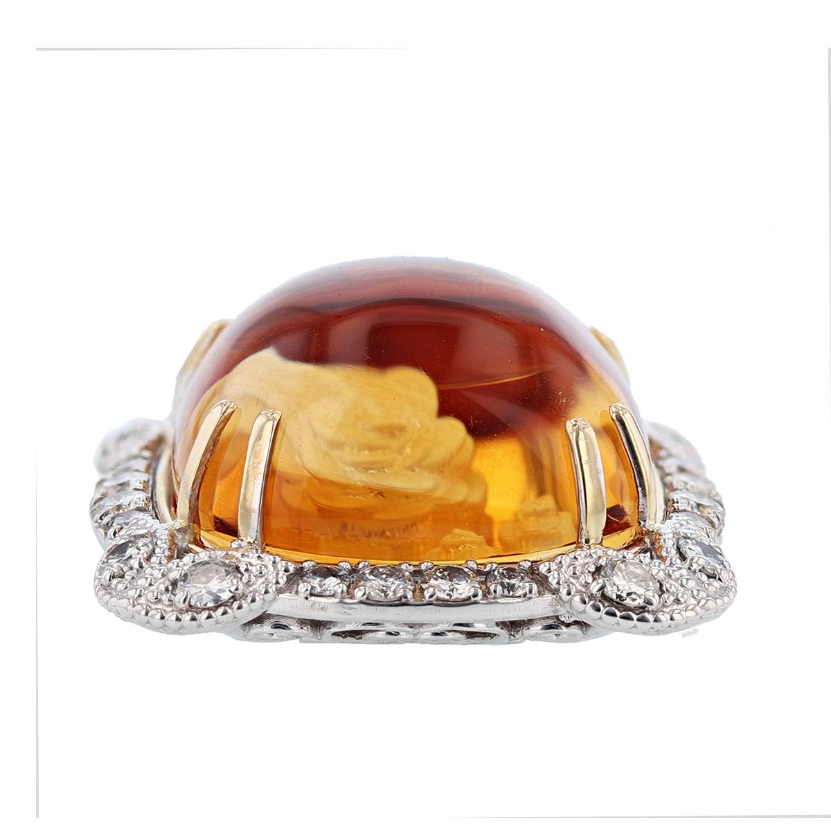 This unique pendant necklace is designed by Nazarelle and made in 14 karat white gold and 14 karat yellow gold. The center stone is a cushion shape cabochon citrine with a special rose design etched in the stone. The pendant features 24 round