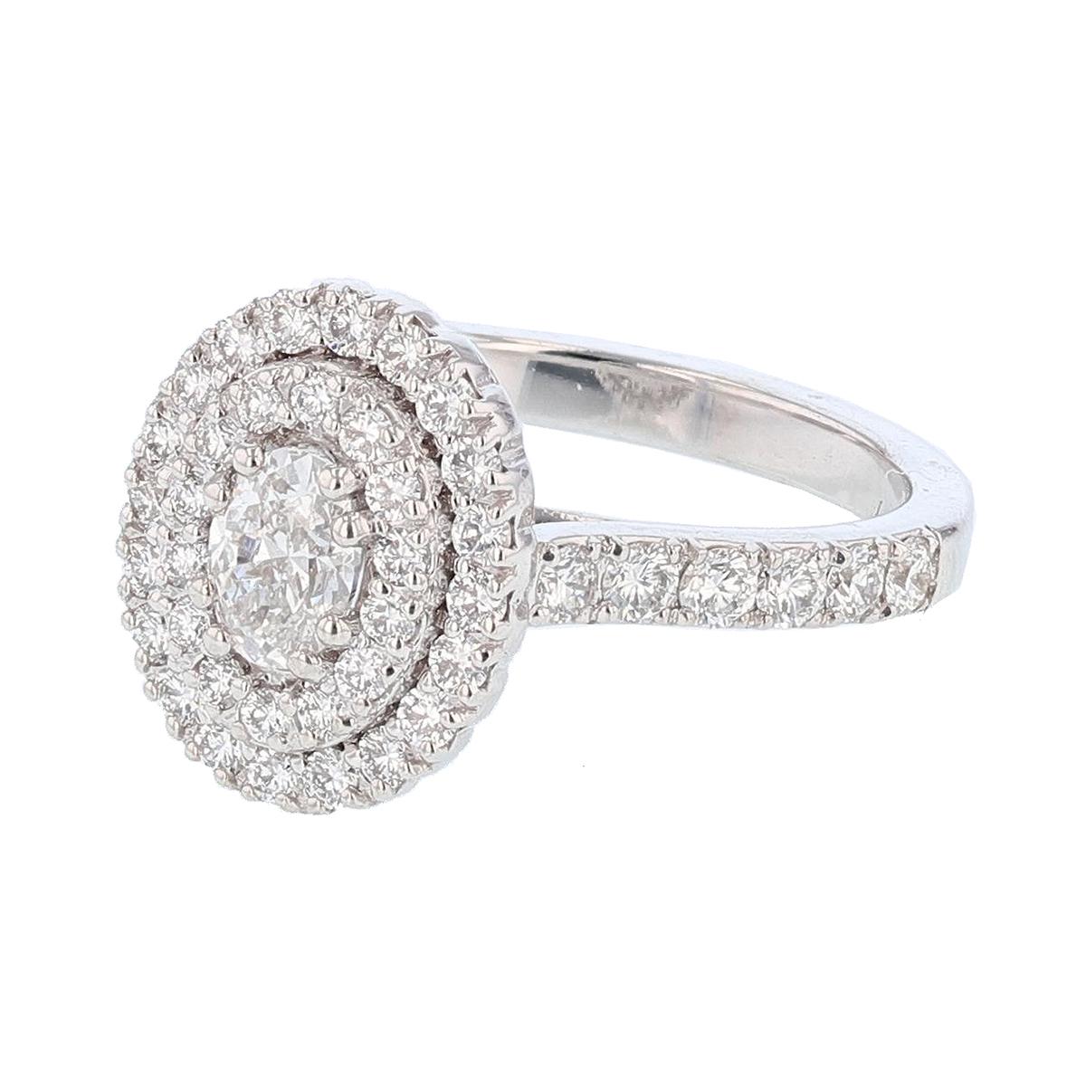 This ring is made with 14 karat white gold and features a prong set  0.46ct  IGI certified oval cut diamond (IGI Certificate number: 5813511), with a color grade (D) and clarity grade (VS2) and is surrounded by 49 round cut diamonds weighing 0.91ct
