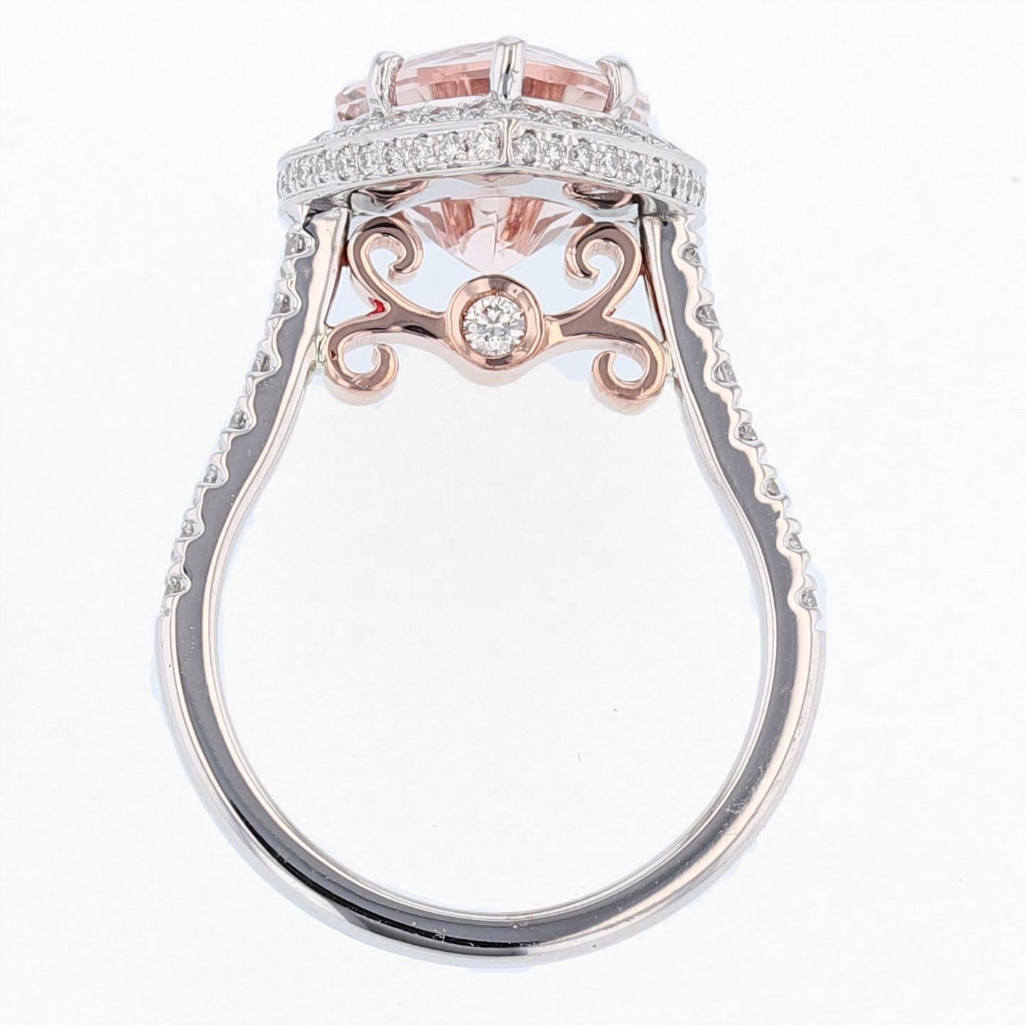 This ring is made in 14K white and rose gold featuring a heart shaped Morganite weighing 3.75CT that is prong set.  The ring also features 80 round cut diamonds that are prong set with a color grade (G) and clarity grade (SI1). 