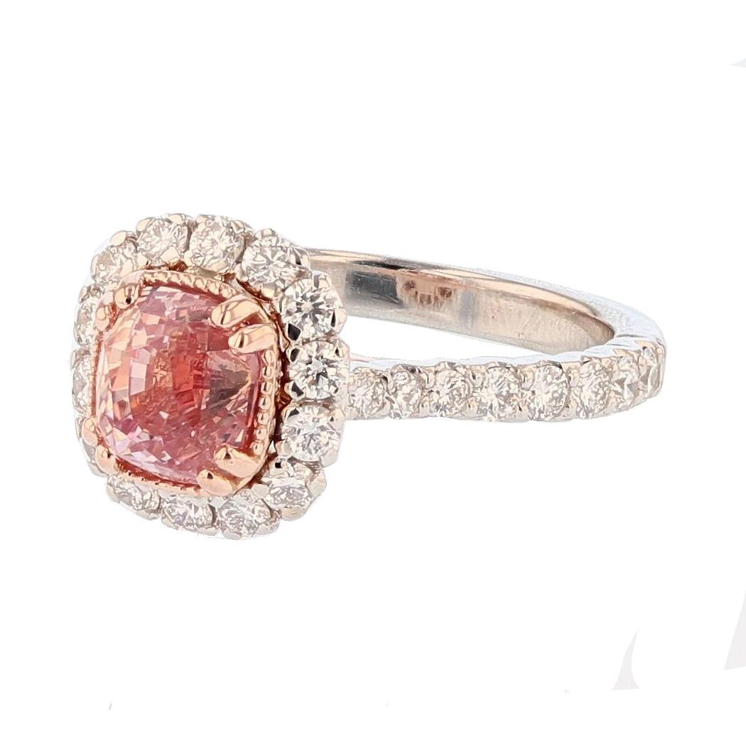 This ring is made in 14K White and Rose gold featuring 1 cushion cut, prong set Pink Padparascha Sapphire weighing 2.67ct (pinkish orange), AGL report 
number GB 8086860 . There are 30 round cut prong set diamonds weighing 1.03ct  and 2 round cut