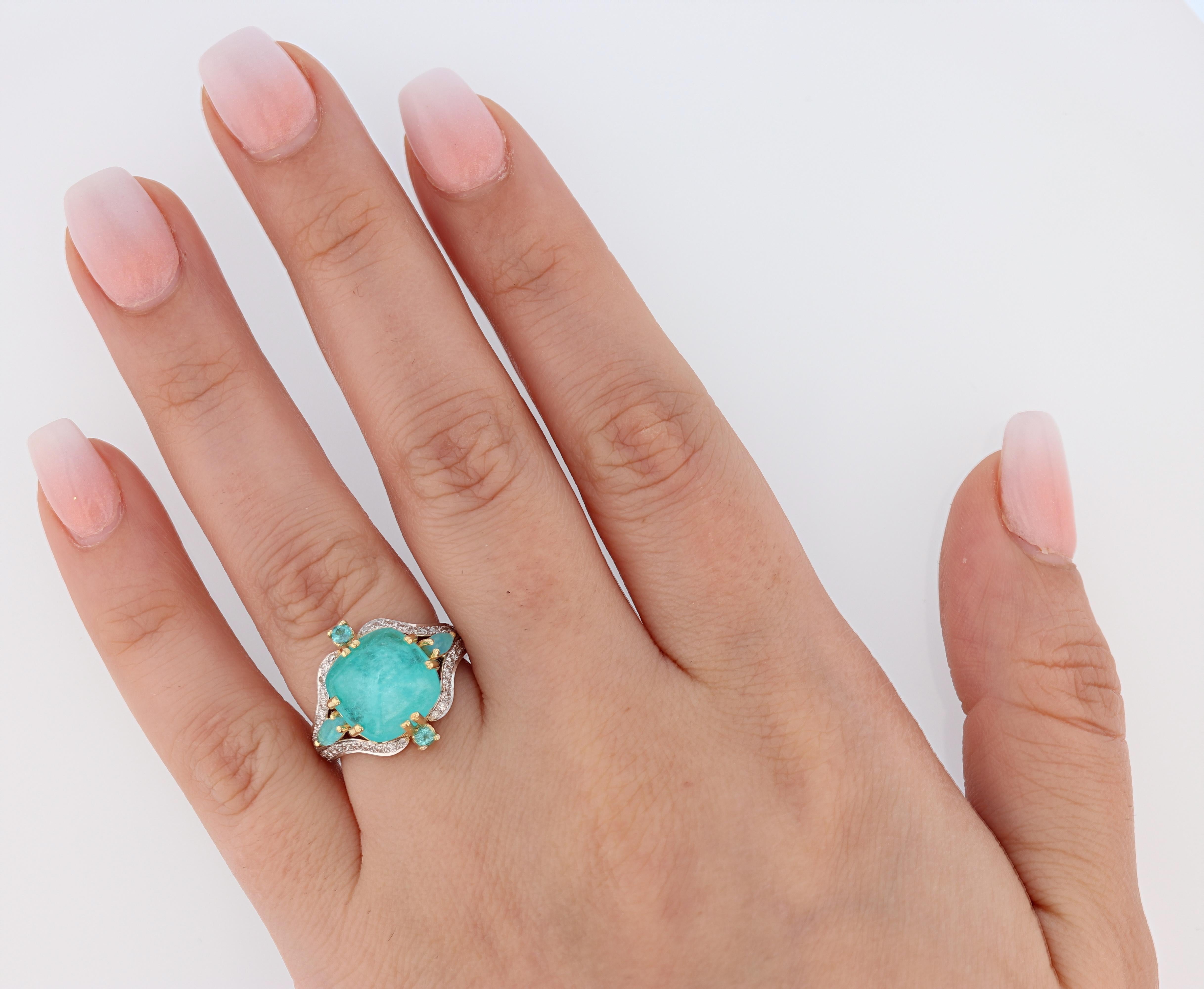 This ring is made in 18k white and yellow gold and features a 5.10 ct cabochon Gia certified paraiba Tourmaline prong set for the center stone. The certificate is 