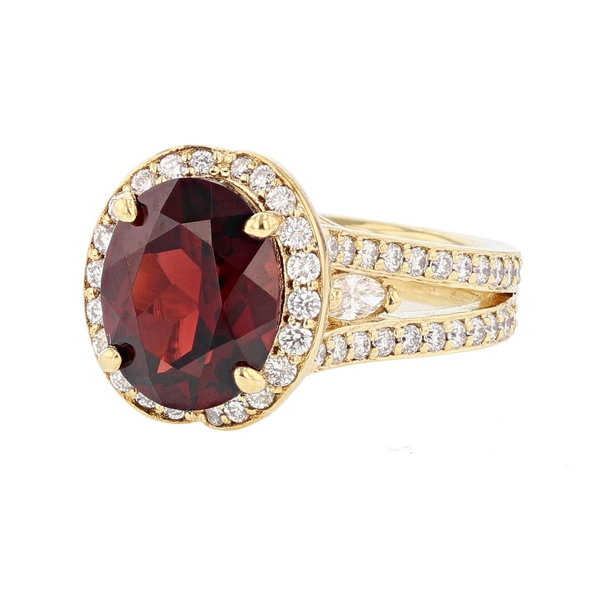 This ring is designed by Nazarelle and made in 18 karat yellow gold. The center stone is an oval shape garnet weighing 4.43 carats and is prong set. The mounting features 4 round bezel set garnets weighing 0.80 carats, 2 marquise shape prong set