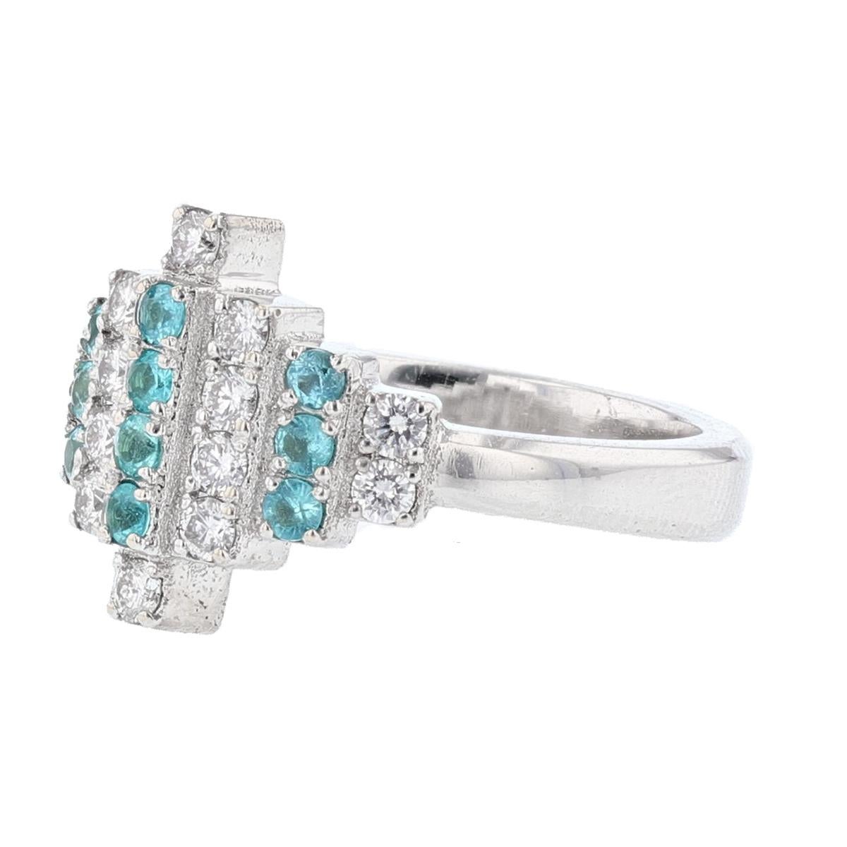 This ring is made in 18K white gold and features 10 round cut, prong set Paraiba Tourmalines weighing 0.24ct and 14 round cut, prong set diamonds weighing 0.38ct with a color grade (G) and clarity grade (SI1). 