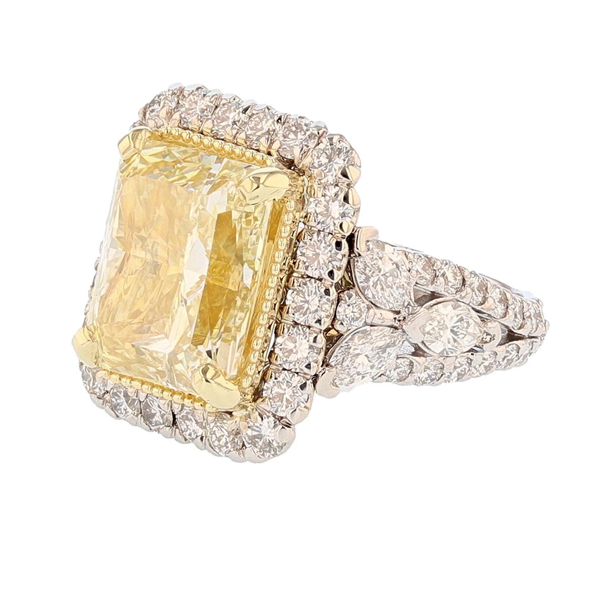 This ring is made in 18k white and yellow gold featuring a GIA certified 10.42ct Fancy Light Yellow radiant cut diamond clarity grade (VS1). The certificate number is GIA 2205182288. The ring also features 82 round cut diamonds prong set weighing