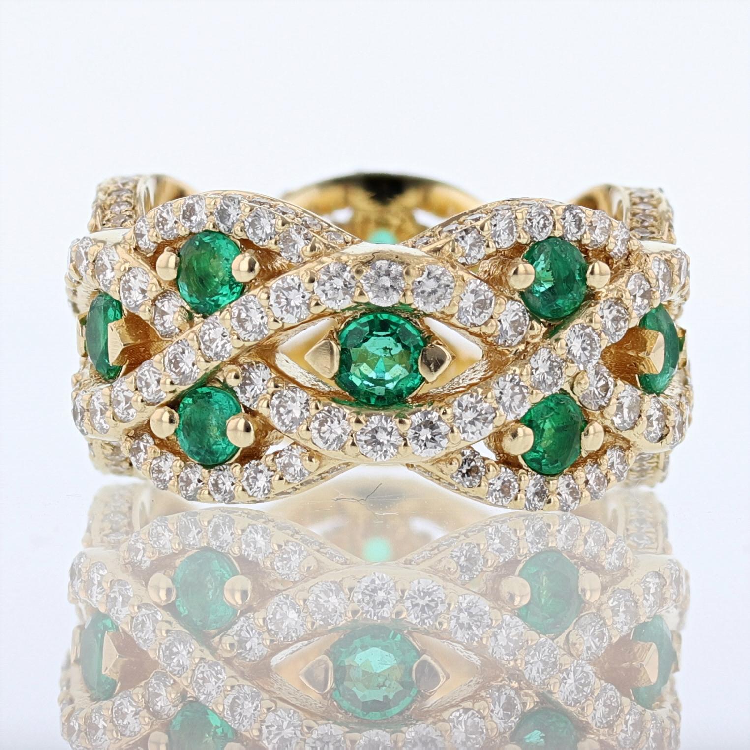 This ring is made in 18k yellow gold and features 15 round cut emeralds weighing 1.45ct. Also the ring has pave and prong set round diamonds all around weighing 1.90ct color grade (G) clarity grade (VS2)
