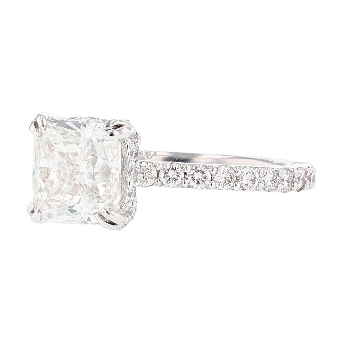 This ring is made in platinum and 14K white gold. The center diamond is a 2.70ct GIA certified cushion cut diamond with a color grade (G) and clarity grade (SI1) clarity. The certificate number is 