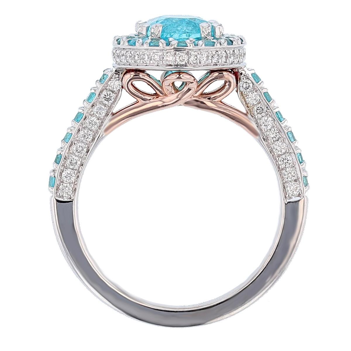 This ring is designed by Nazarelle and made in 14k white and rose gold. For the center stone it features one oval Paraiba Tourmaline from Brazil, GIA certified (GIA: 2151487144 ) weighing 1.89ct, prong set. The mounting features 28 prong set round