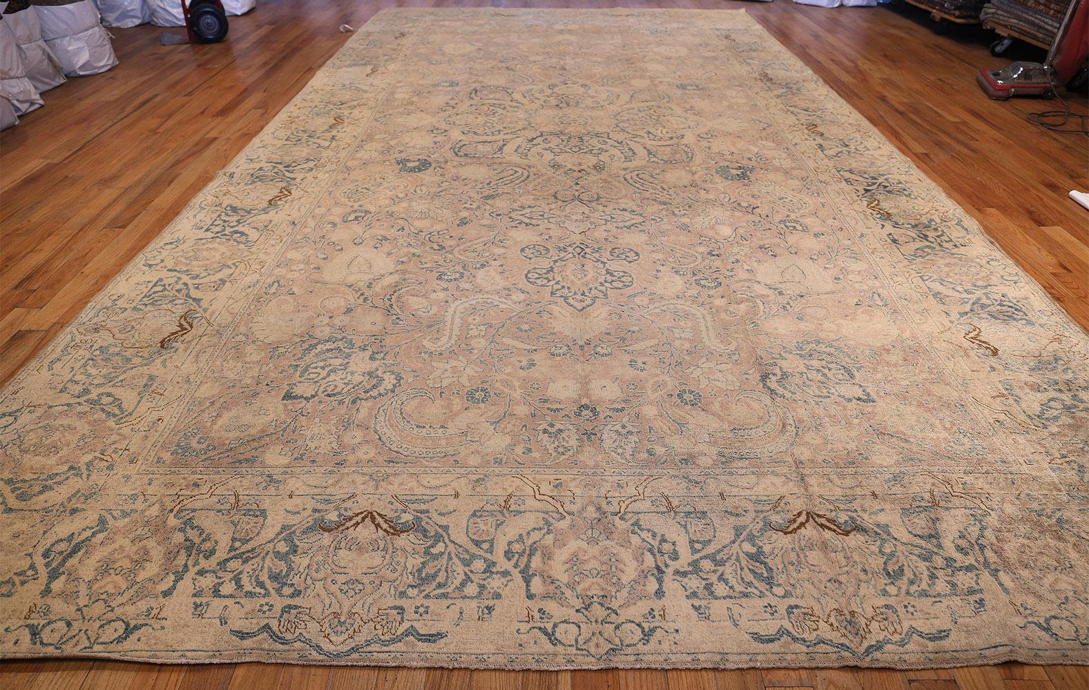 Beautiful large size antique and finely woven Persian Kerman rug, country of origin: Persia, circa date: late 19th century. Size: 10 ft x 19 ft (3.05 m x 5.79 m) 

A large medallion fills the middle of this antique Persian rug, crafted with equal