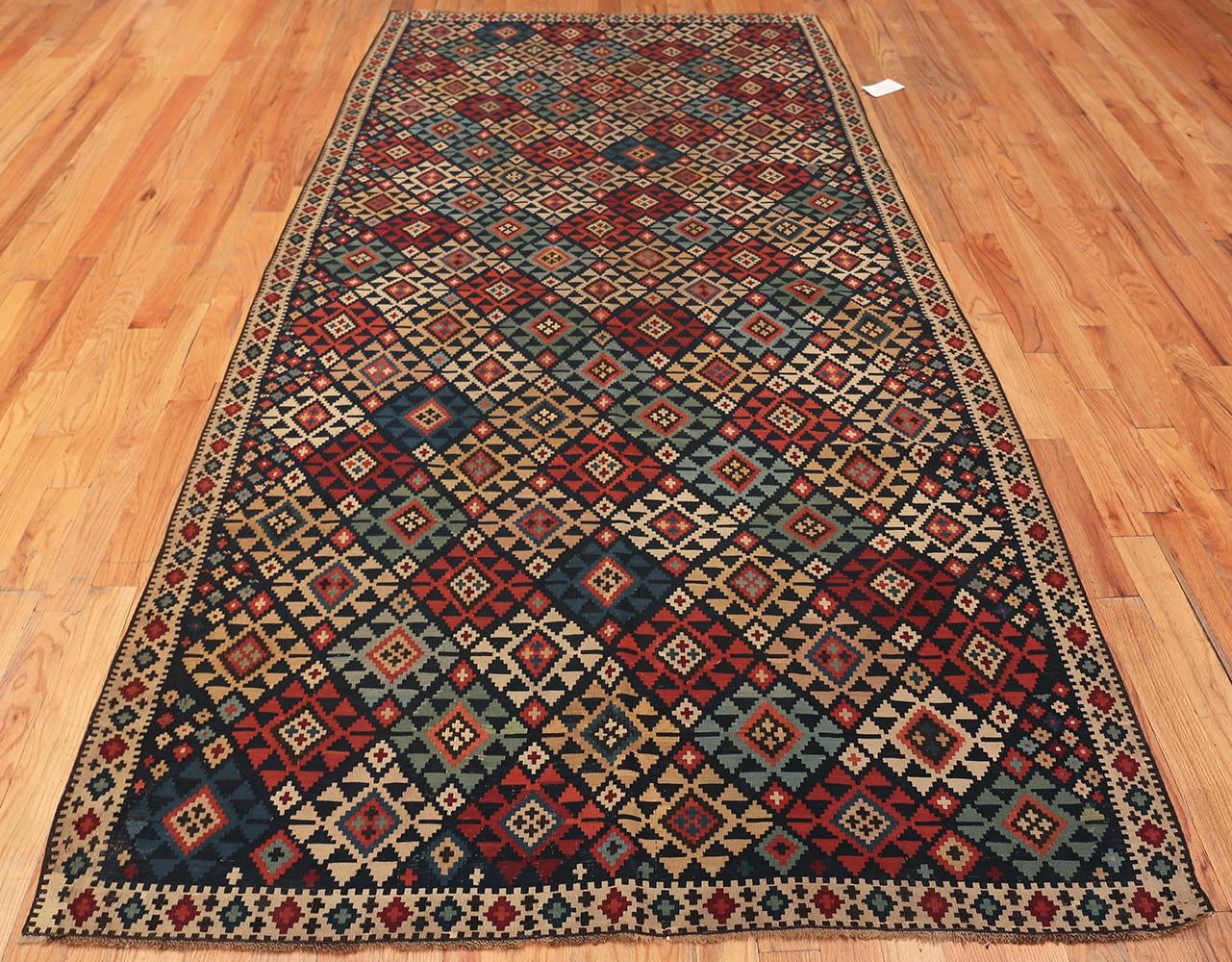 Fine Tribal Antique Caucasian Shirvan Kilim Rug, Country Of Origin / Rug Type: Caucasian Rugs, Circa Date: 1900 – This gorgeous Shirvan carpet is perfect for traditional or contemporary decor. Its geometric pattern is a perfect complement for many