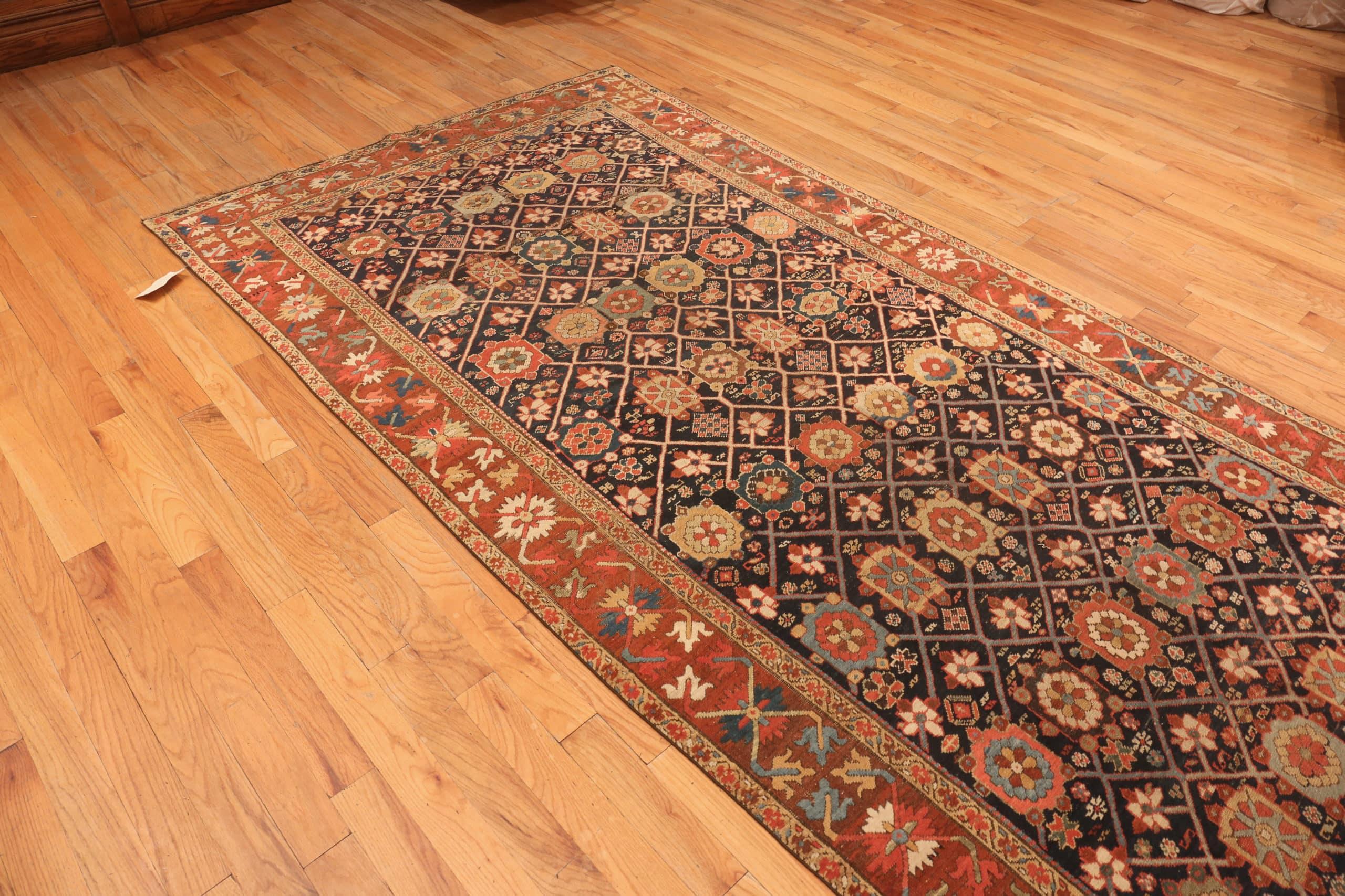 Tribal Antique Northwest Persian Rug, Country of Origin / Rug Type: Persian Rugs, Circa Date: 1880 – Size: 5 ft 5 in x 14 ft (1.65 m x 4.27 m)

This Northwest Persian rug is unique because of its angular forms and vibrant colors, reminiscent of