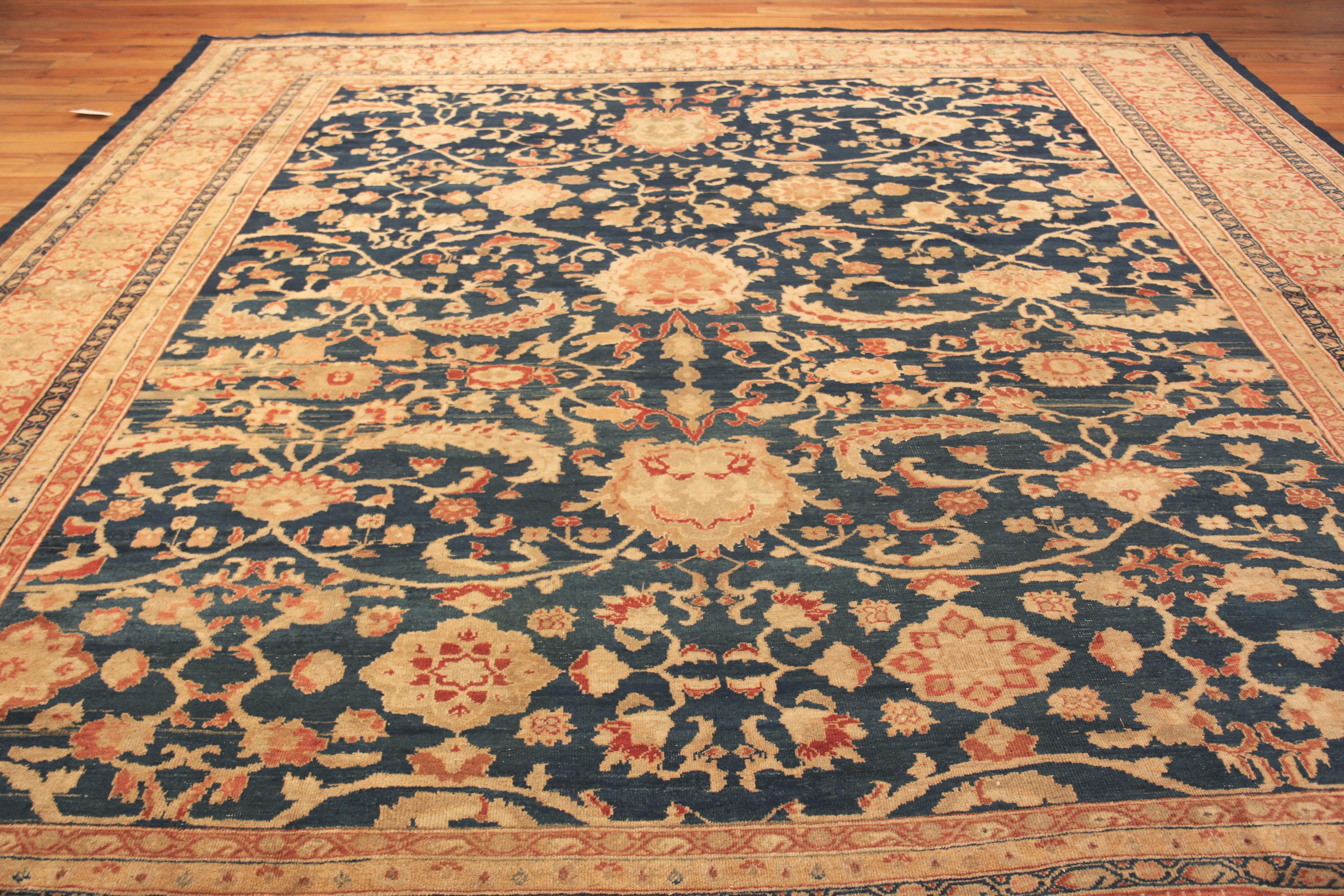 Impressive Blue Background Antique Persian Sultanabad Rug, Country of Origin: Persia, Circa date: 1890 – Sultanabad holds a unique place in the world of Persian carpets. Until 1808, it was known as the city of Arak. The area has a long history of