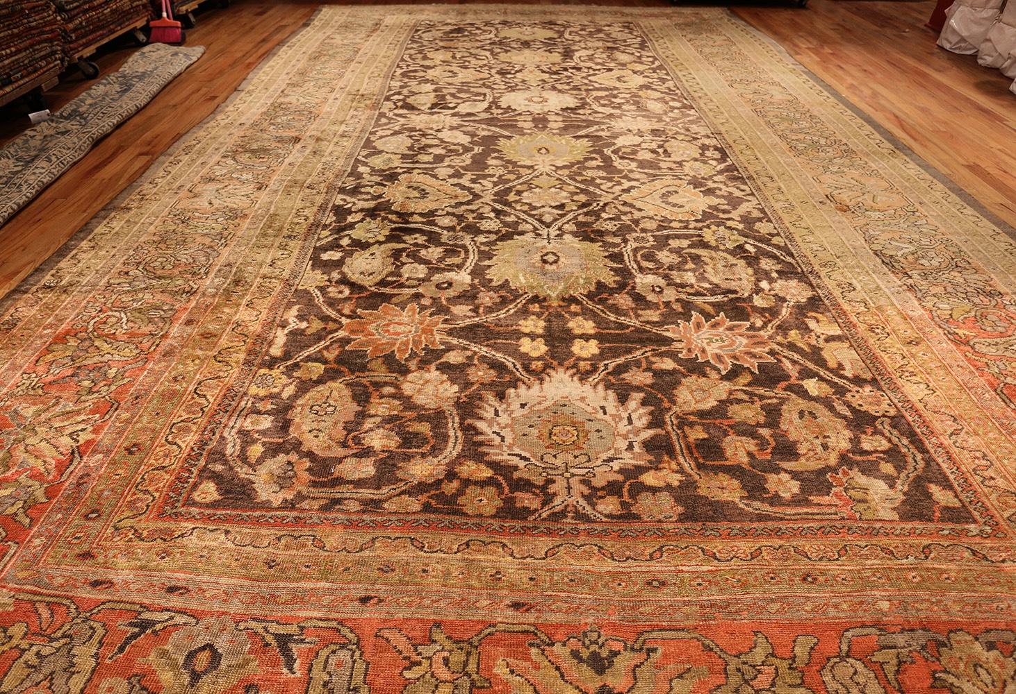 Beautiful and decorative earth tone oversized antique Persian Sultanabad rug, origin: Persia, circa late 19th century. Size: 12 ft x 21 ft 8 in (3.66 m x 6.6 m)

Warm corals and earthy browns work together to create this Persian antique Sultanabad