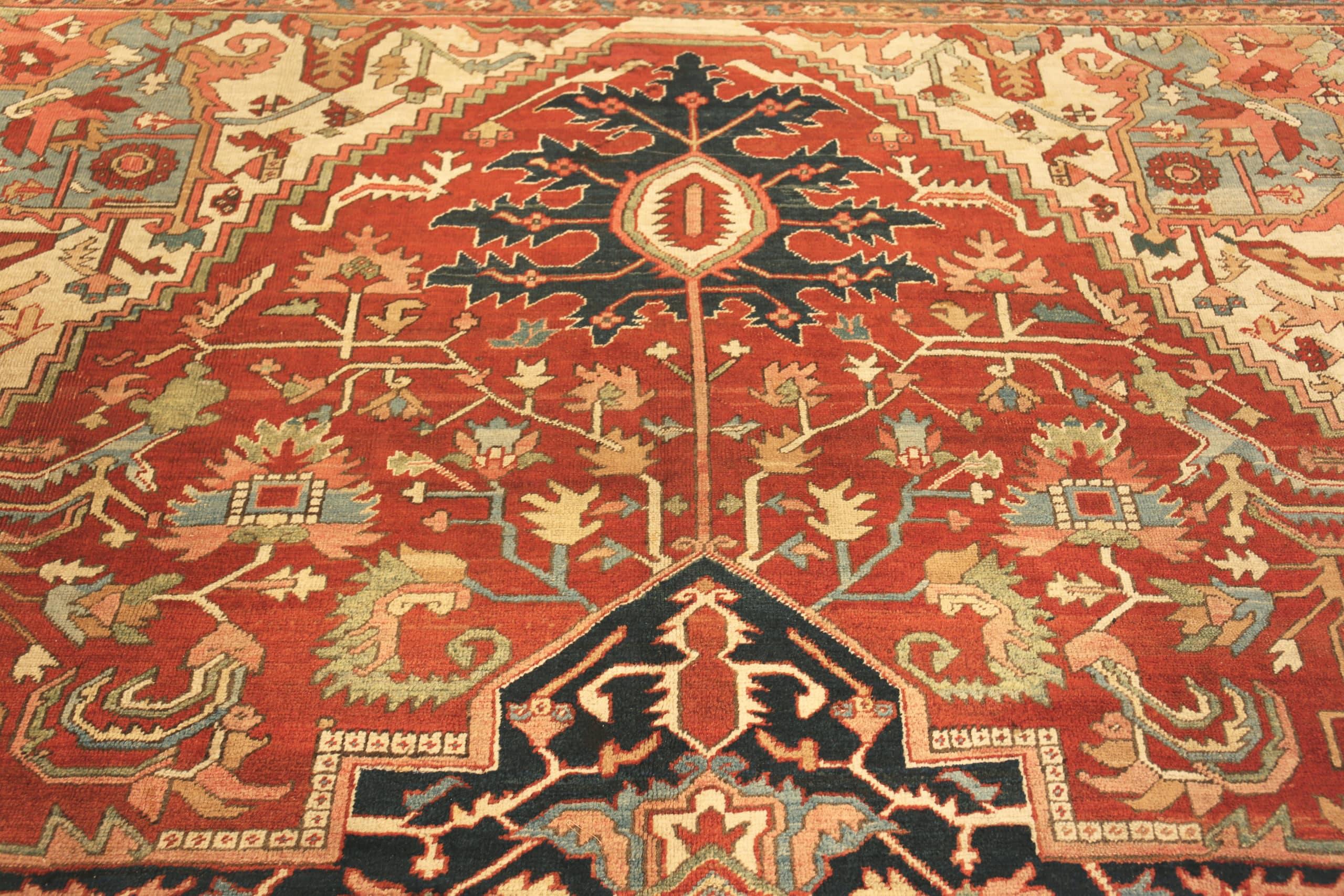 Geometric Large Rustic Antique Tribal Persian Heriz Medallion Rug, Country of Origin: Persia, Circa date: 1920. Size: 11 ft 4 in x 17 ft 8 in (3.45 m x 5.38 m)
