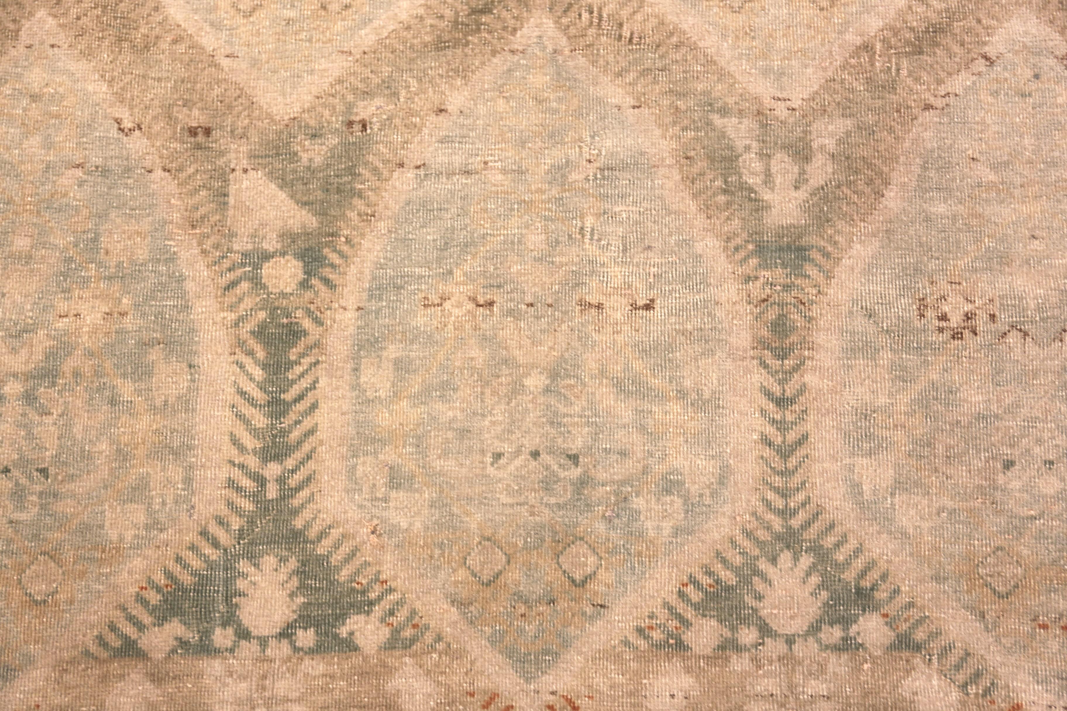 Decorative Open Field Antique Persian Tabriz Rug, Country of origin: Persian Rugs, Circa date: 1920 - This antique Persian Tabriz rug, woven in the late 19th century, presents a rare study in restraint and refinement. Known for their precision and