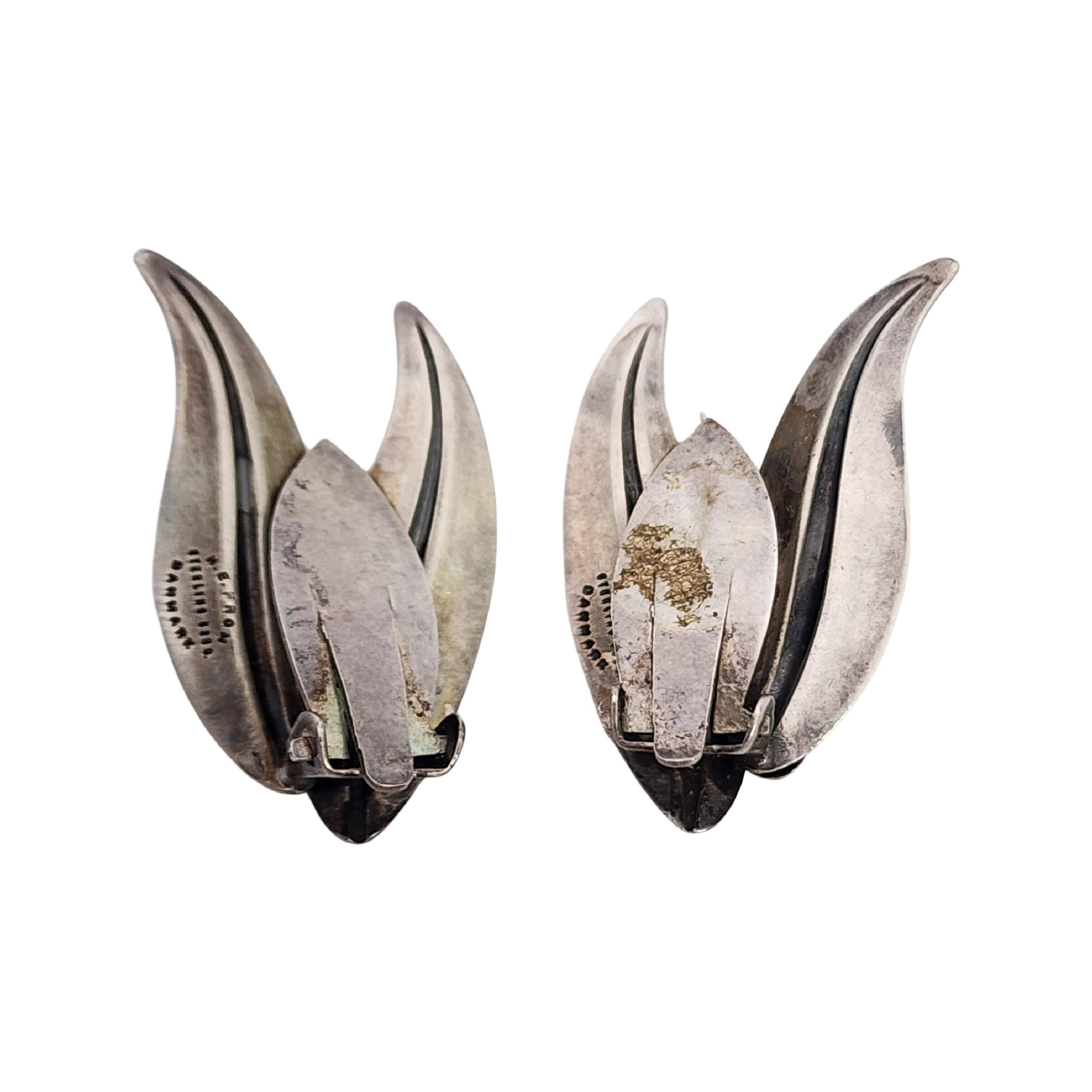 Vintage sterling silver leaf clip-on earrings by Niels Erik From of Denmark.

Niels Erik From was one of the great Danish silversmiths and designers from 1931 thru his death in the 1980s. He created many floral and nature inspired design of the