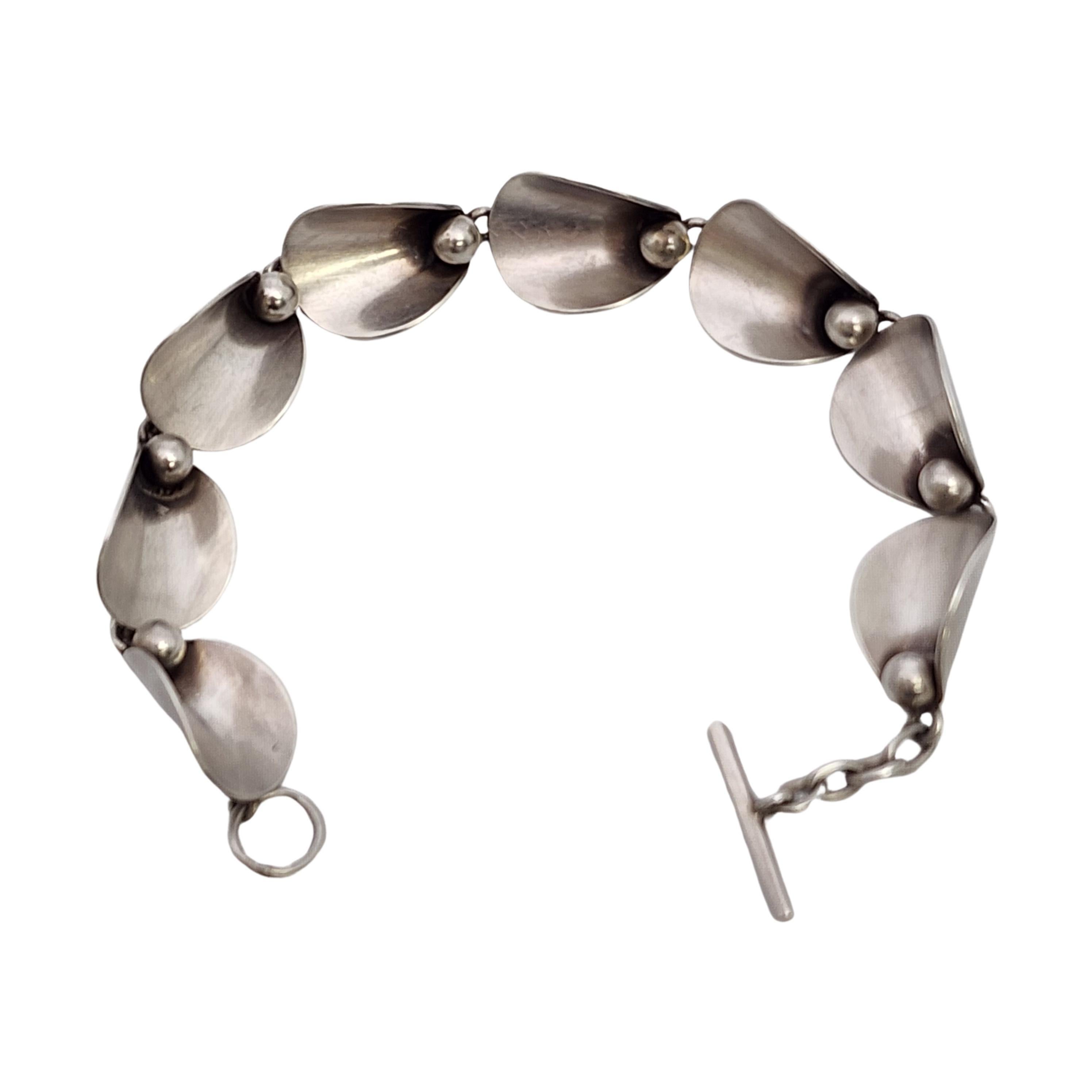 Vintage sterling silver modernist link bracelet by Niels Erik From of Denmark.

Niels Erik From was one of the great Danish silversmiths and designers from 1931 thru his death in the 1980s. He created many floral and nature inspired design of the
