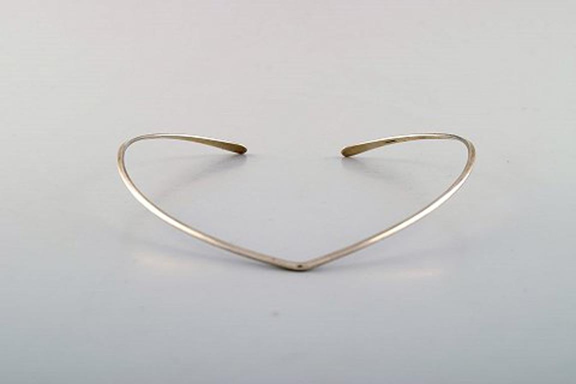 N.E. From sterling silver neck ring. Danish design 1970's.
Neck ring interior 13.5 to 14.5 cm. 
In perfect condition.
Stamped.