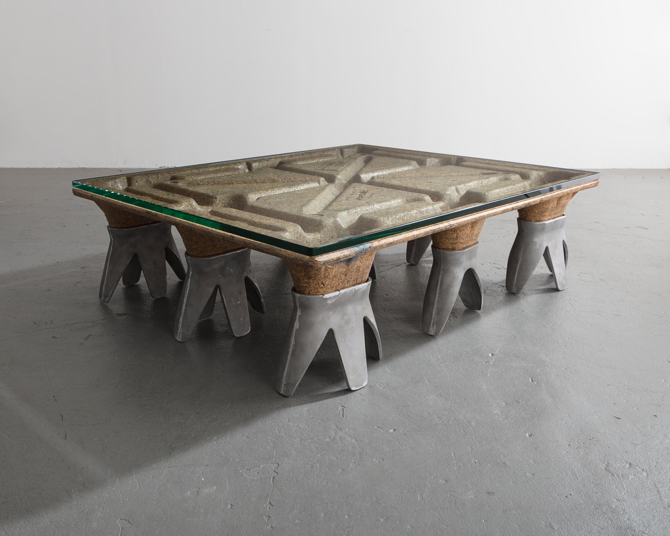 NEA table, Version 1 in particleboard skid, cast aluminum and glass. Designed by Ali Tayar, 1995.