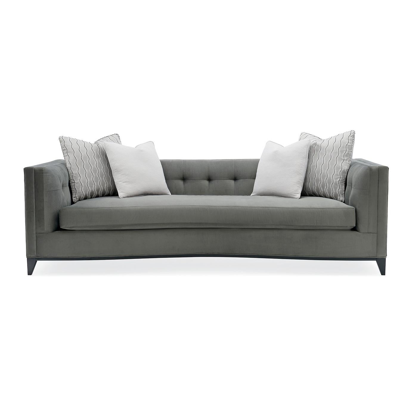Neah mid century tufted sofa. Relax and unwind in style with the generous proportions and unique character of this sofa. Its button-tufted arms and back ensure its comfort while conveying refined elegance. Upholstered in a flannel grey strie velvet,
