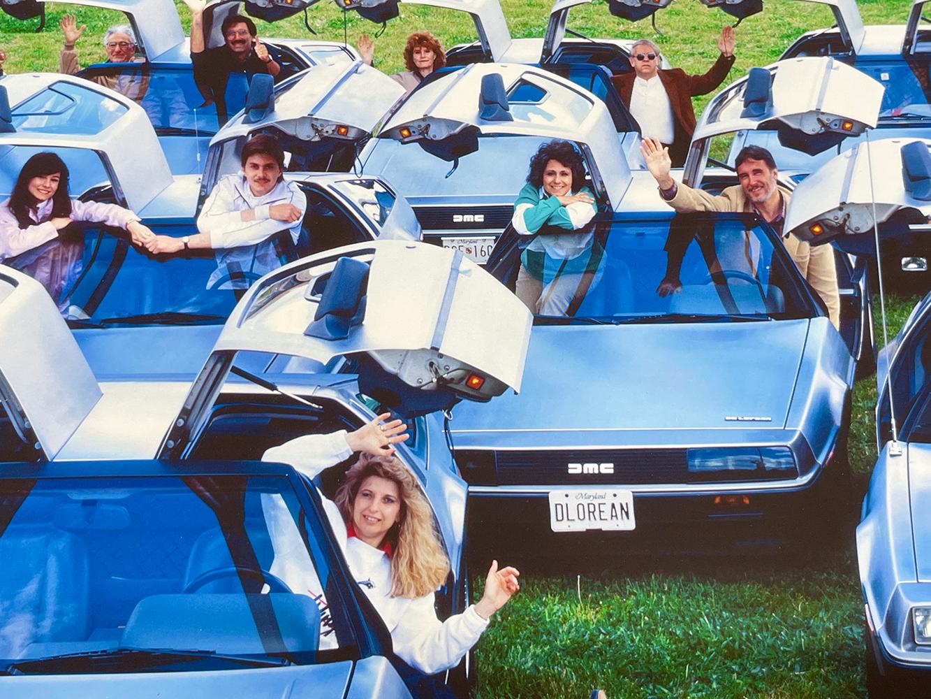 Delorean Club - Ritratto di gruppo a colori, Auto d'epoca, Sci-Fi - Portrait Photograph Grigio di Neal Slavin