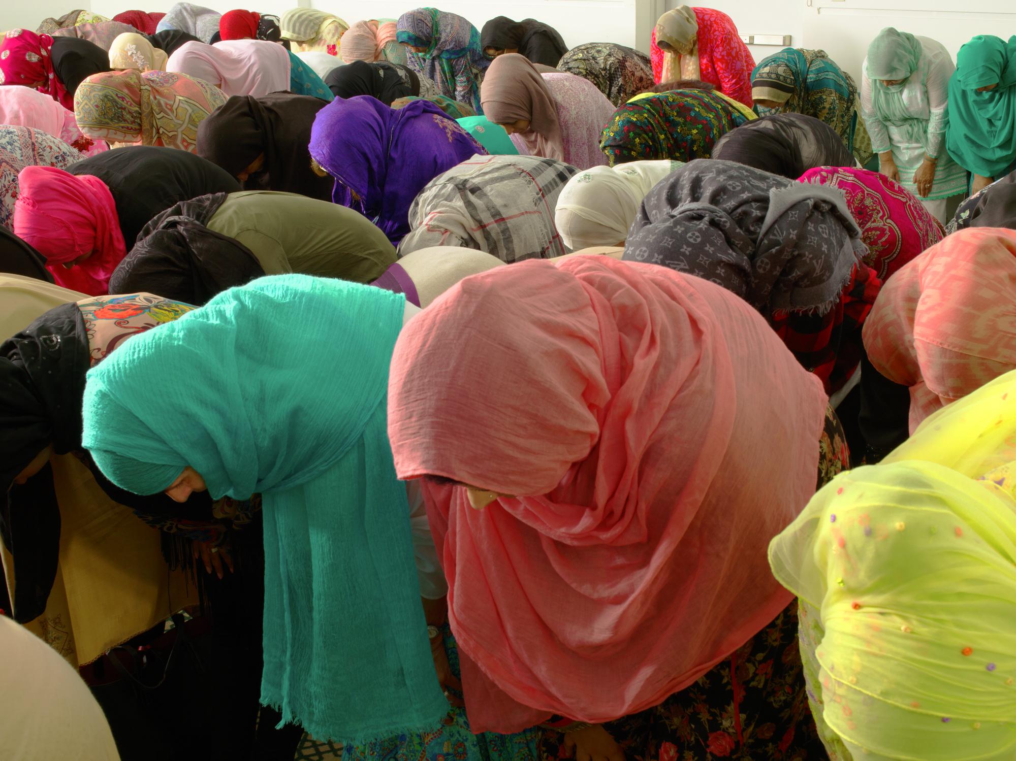 Neal Slavin Color Photograph - Muslim Women Bowing, New York City