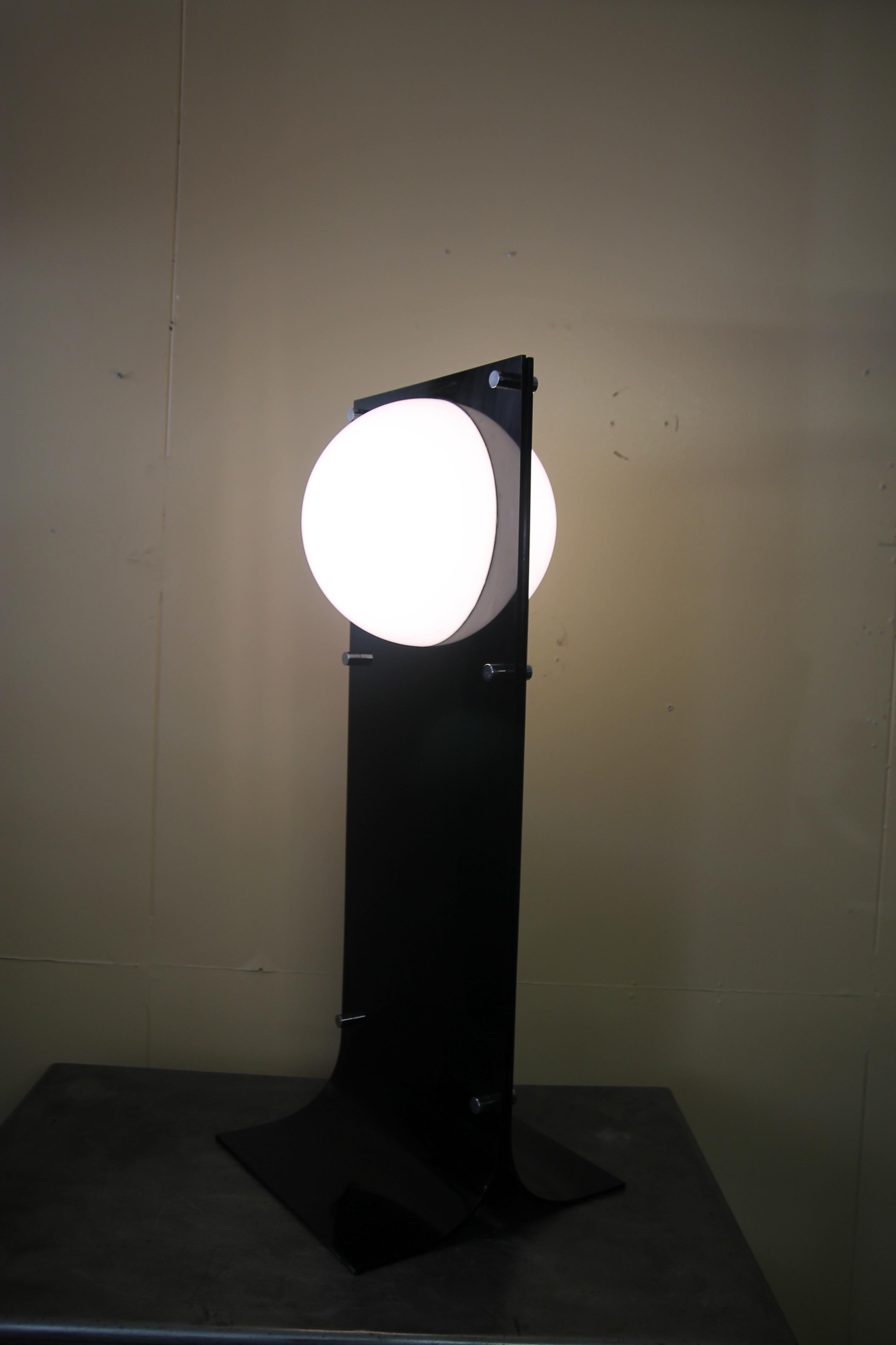 Rare black acrylic lamp by Neal Small. Very seldom do you see the black version of this lamp. With a height of 39.75 this lamp can be used as a floor lamp or tall table lamp. Has a wonderful glow to it when it is turned on.