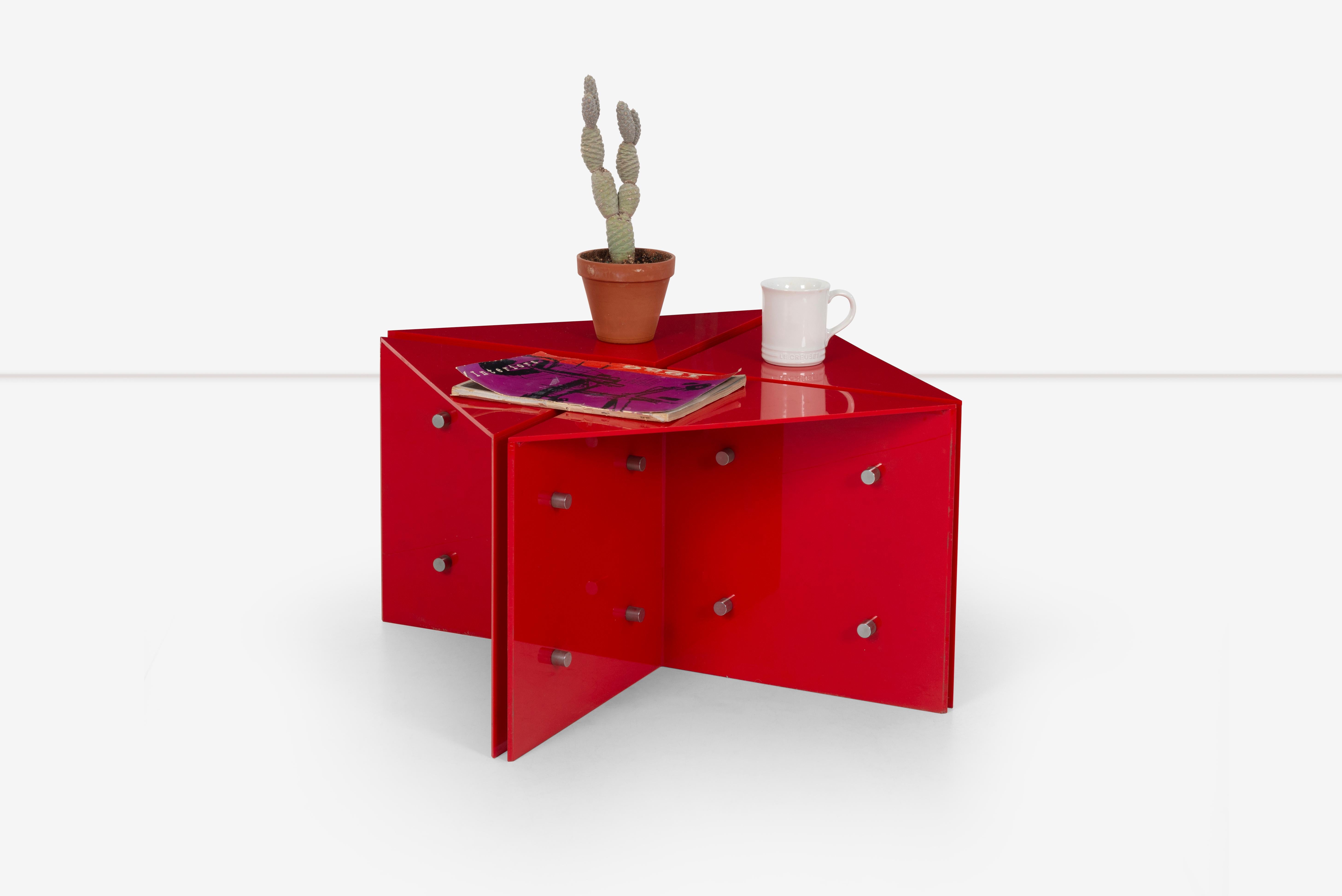 The Neal Small red acrylic side table is a stunning and eye-catching piece of furniture. The vibrant red color adds a pop of color to any room, creating a focal point that draws the eye. The high-quality acrylic material gives the table a sleek and