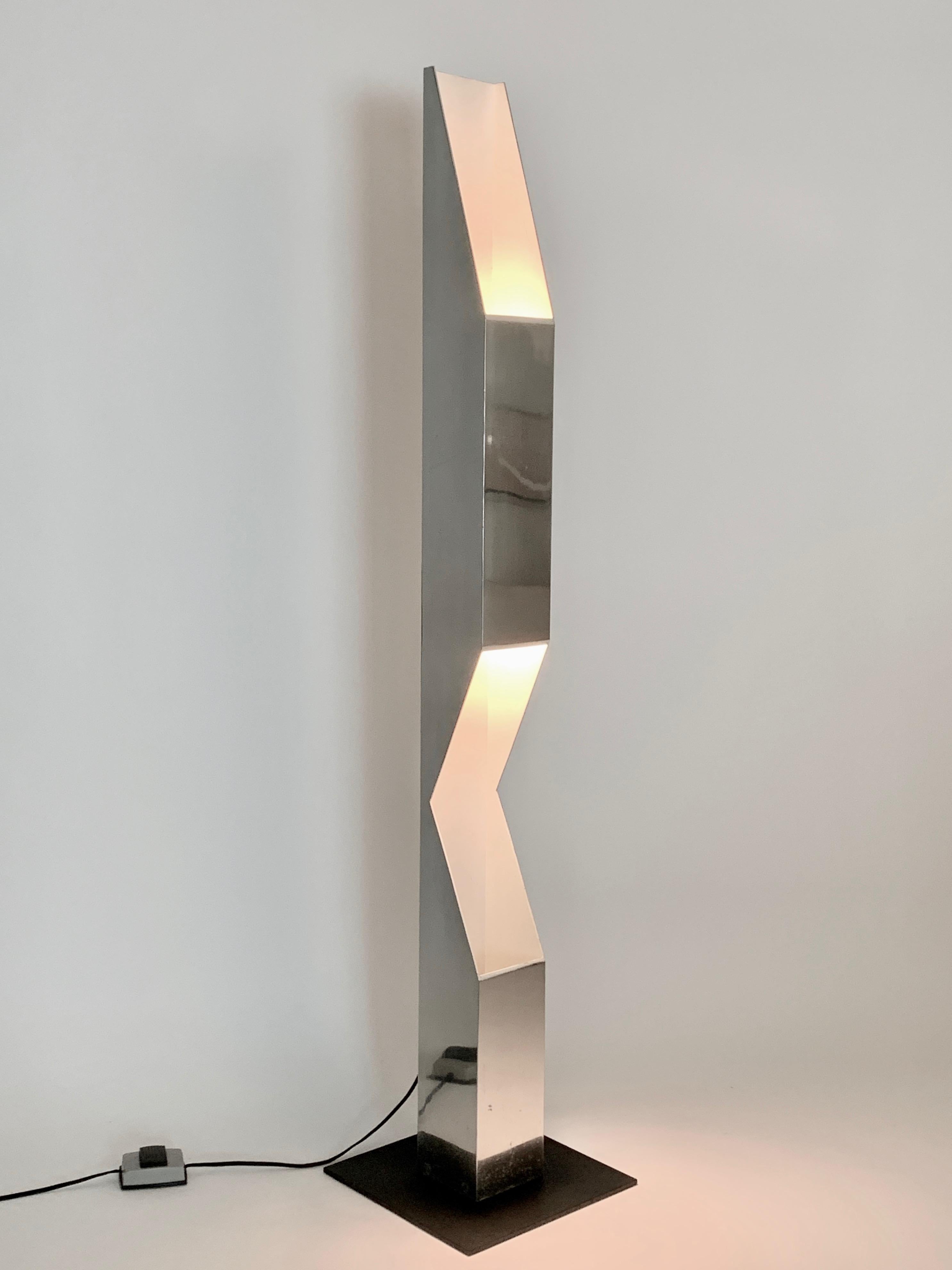 Neal Small for Koch & Lowy polished aluminum periscope, tower floor lamp. In sculpted reflective aluminum, with white enamel interior atop a balanced, heavy, square, black enameled steel base. Double sided standard size ceramic socket. Floor switch.