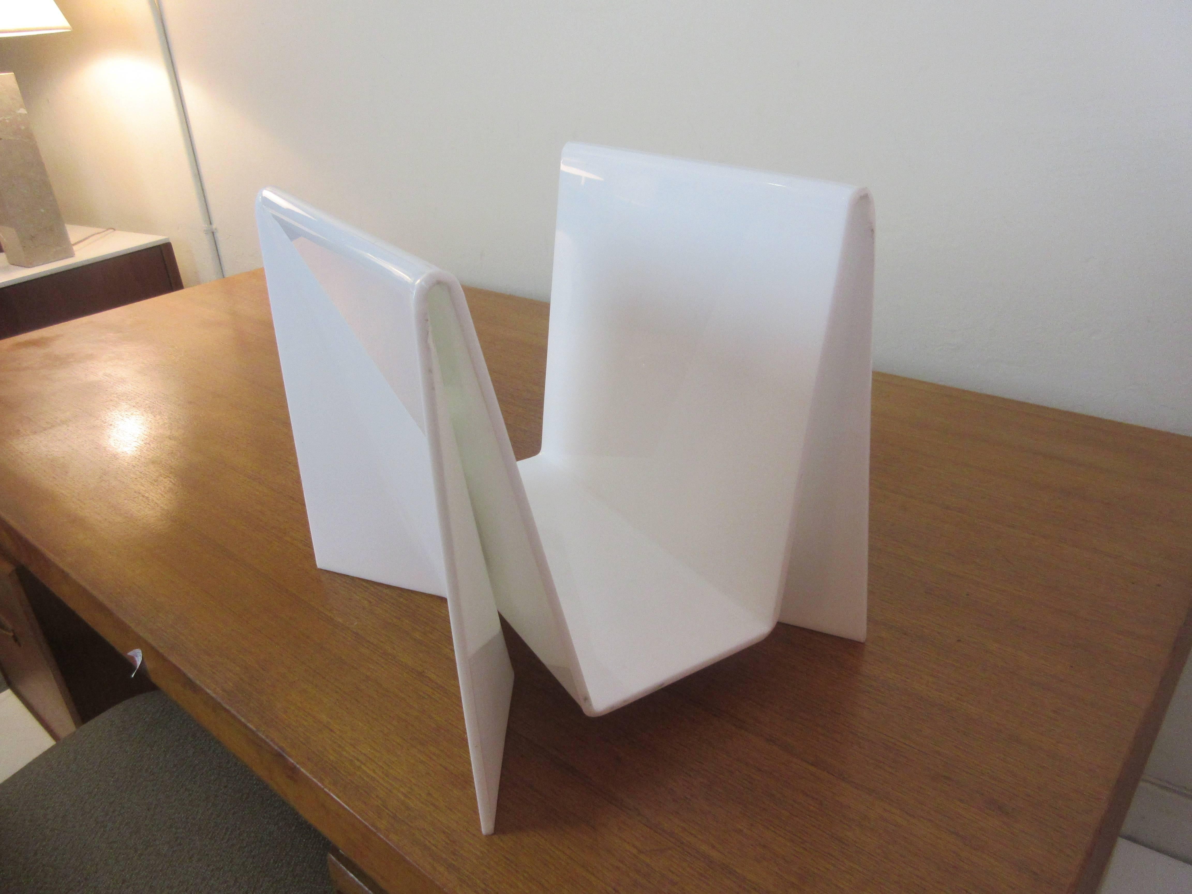 Neal Small white acrylic orgami series magazine rack consisting of planes of rectangles and diamond shapes.