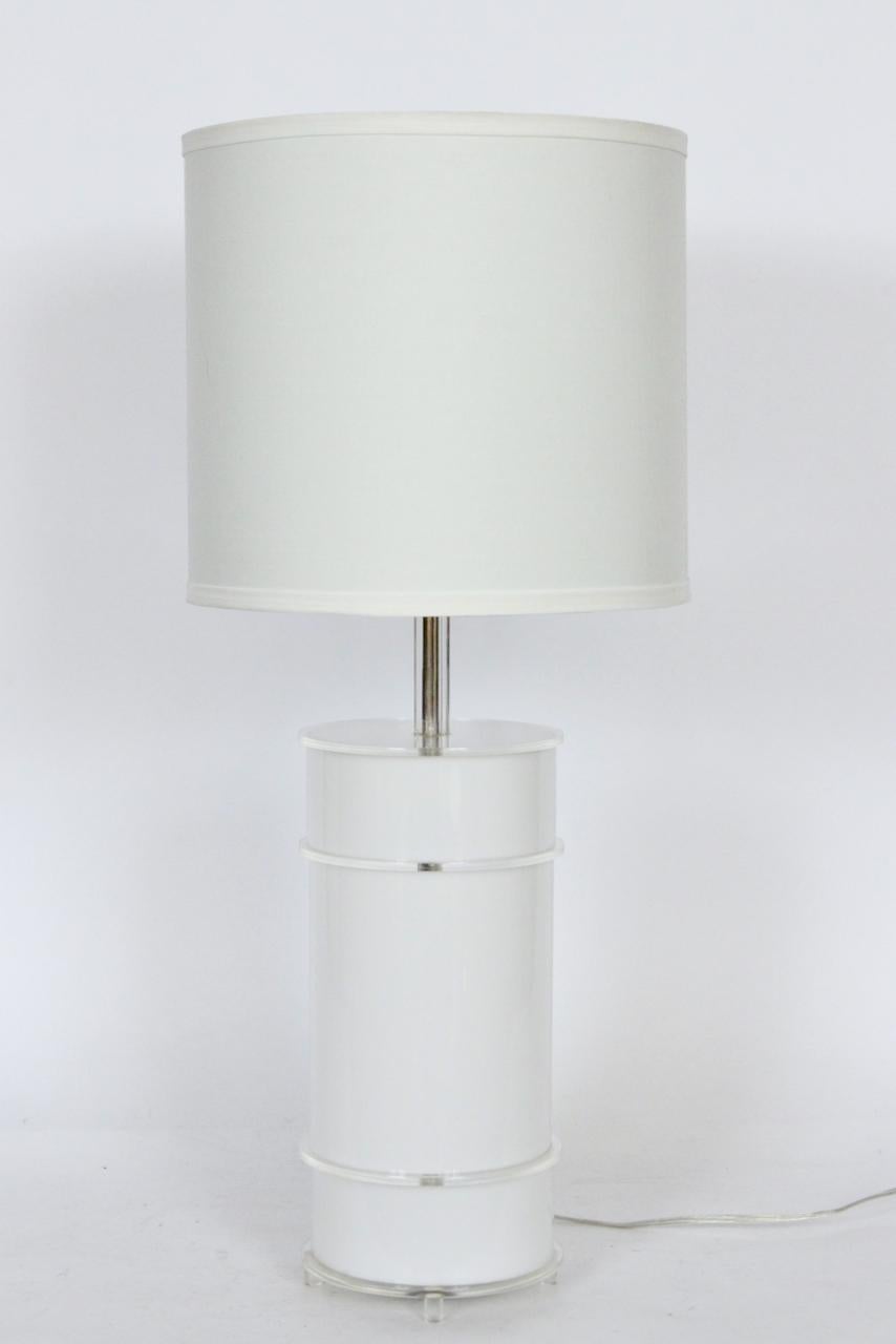 Pop minimalist neal small style white Lucite table lamp with clear disc accents.  Featuring a column form in White Lucite with 4 clear circular disc surrounds a top four Clear cylindrical Lucite footed base. 21H top top of socket. 13.5H to top of