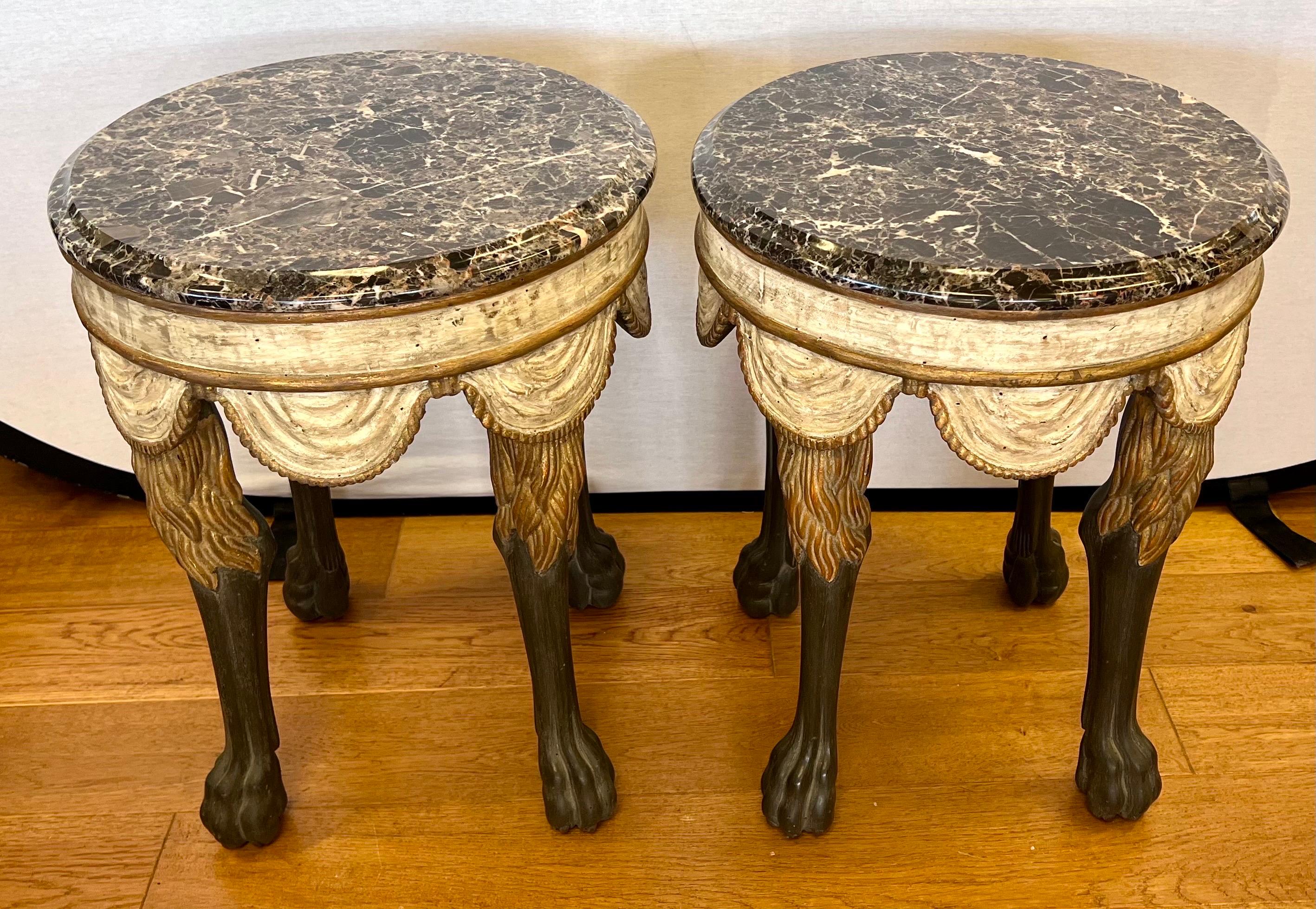 Elegant pair of Neapolitan style tables or stolls with the round marble top on a hand carved and hand painted, with swagged fabric and stylized lions legs and paws.