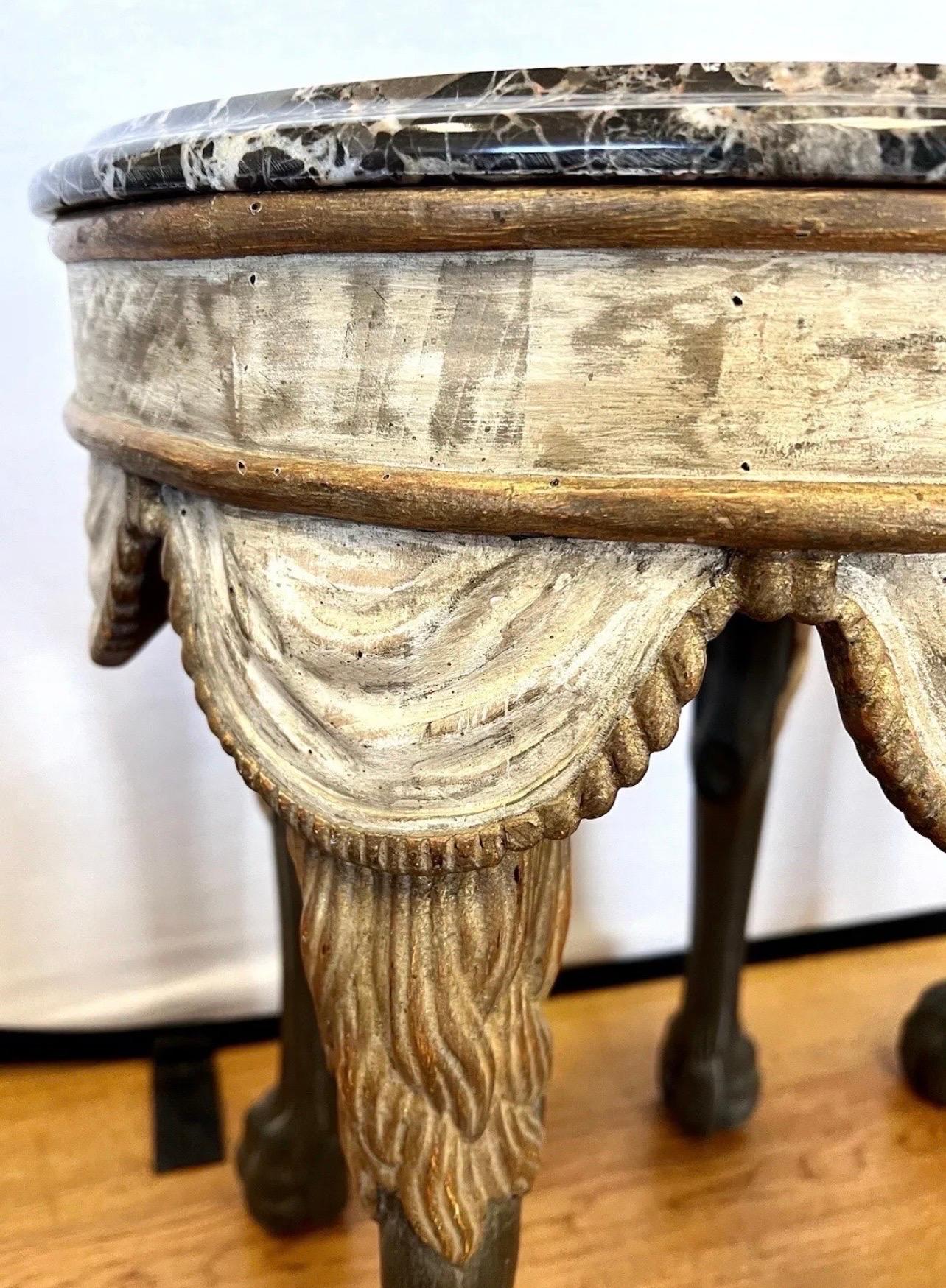 Elegant Neapolitan style table or stool with the round marble top on a hand carved and hand painted with  swagged fabric and stylized lions legs and paws.  The height of luxury.  Just the one, we do not have a pair.