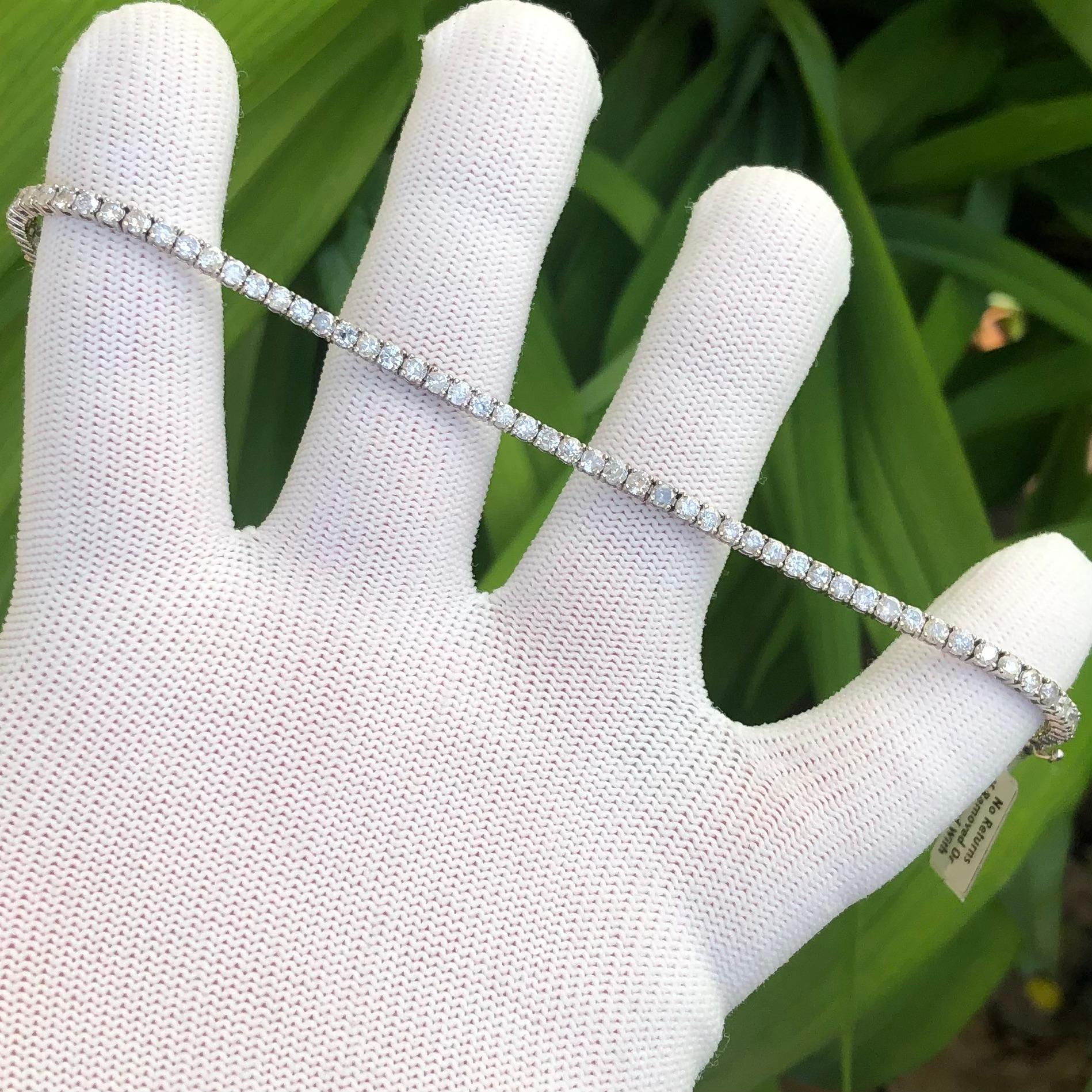 Classic Near 5 1/2 carat round natural diamond tennis link bracelet in 14k white gold. 63 round brilliant natural diamonds (SI-I clarity, natural earth-mined) are hand set in this diamond tennis bracelet weighing near 5 1/2 carats.


This near 5 1/2