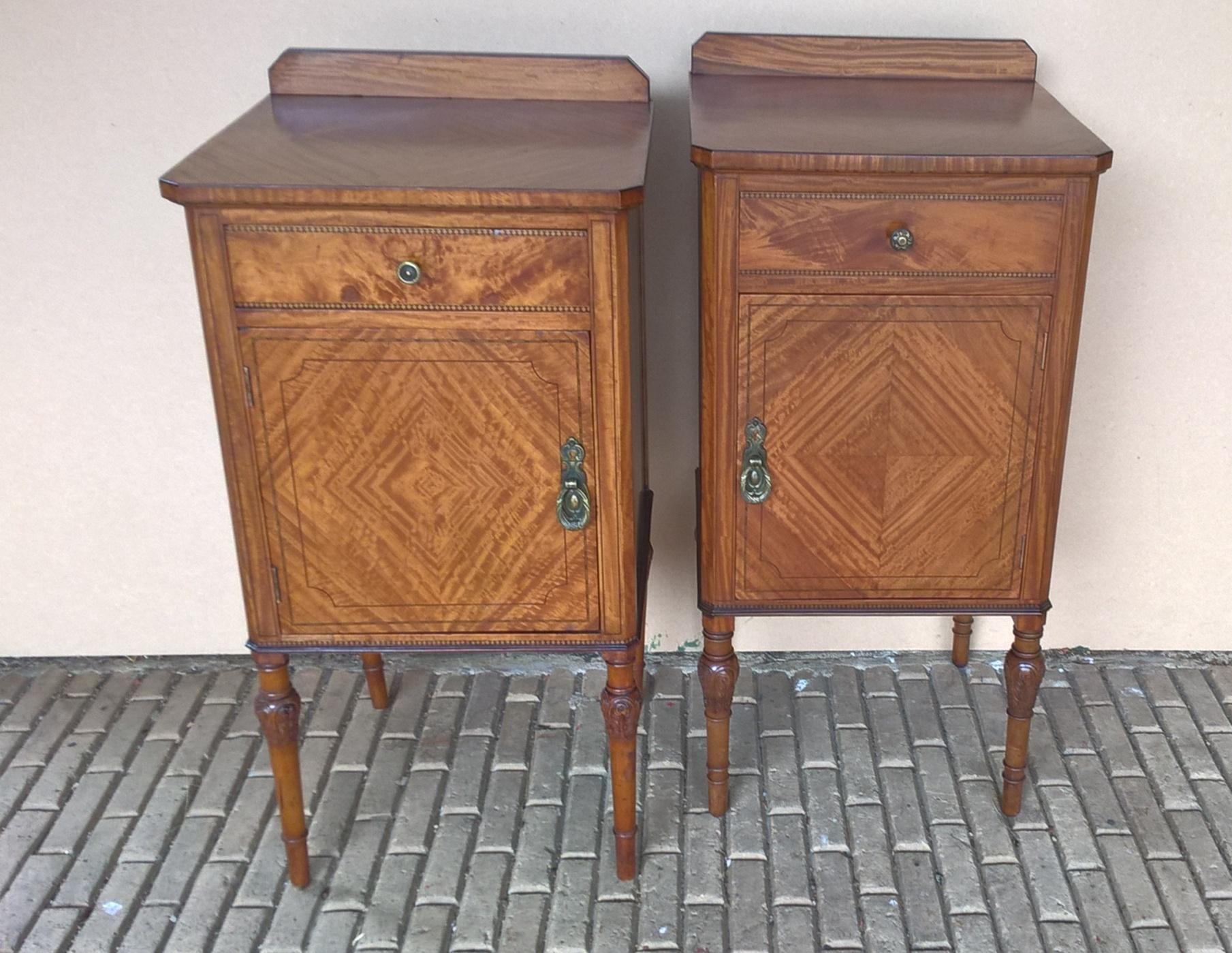 A near matched right and left opening Edwardian satinwood bedside cabinets.
Each with an upstand to the back, a quarter veneered top and a mahogany lined drawer below.
The quarter veneered doors open to reveal an interior with a single shelf.
The