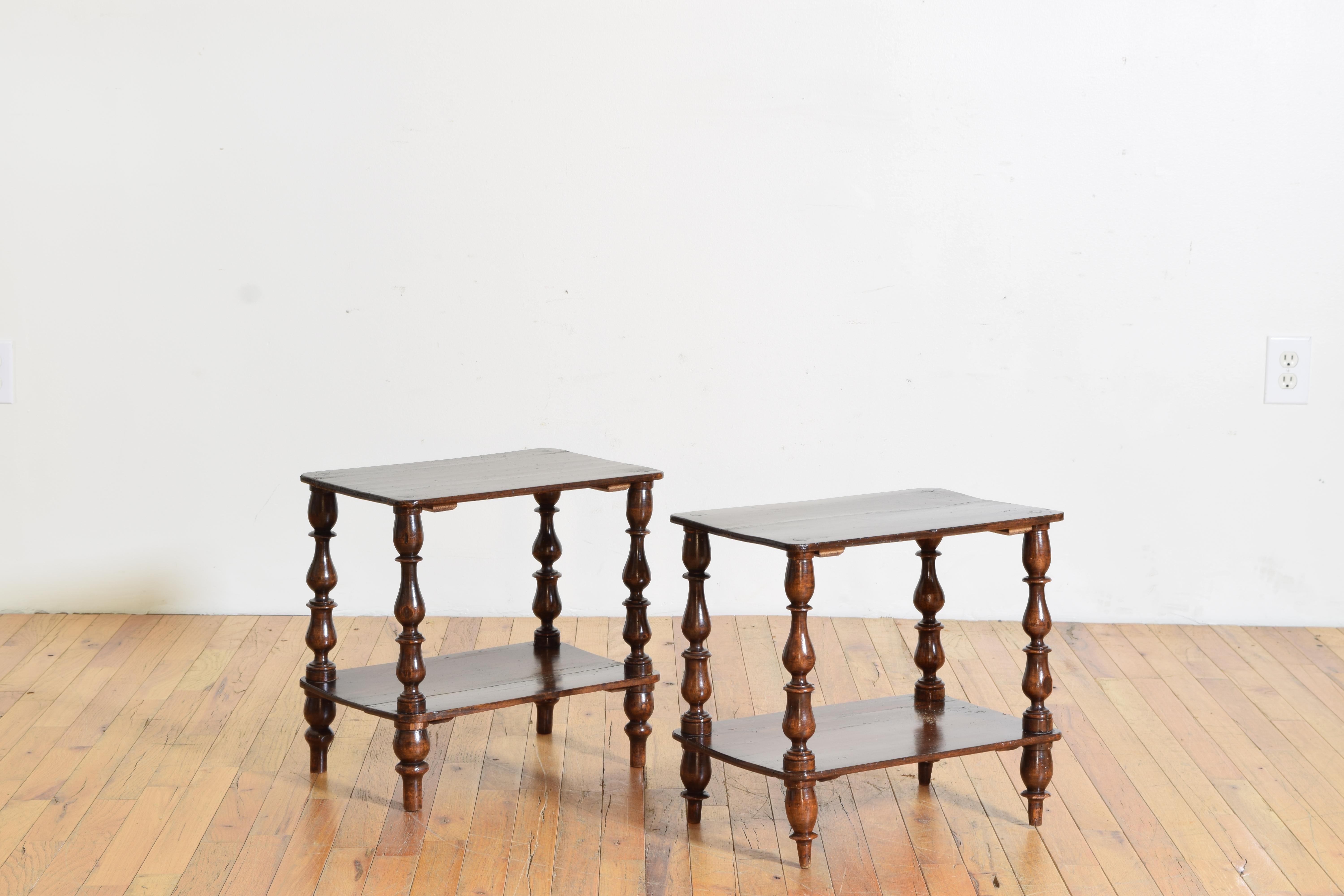Each table having a rectangular top with rounded corners with conforming lower tiers, joined by turned legs and feet