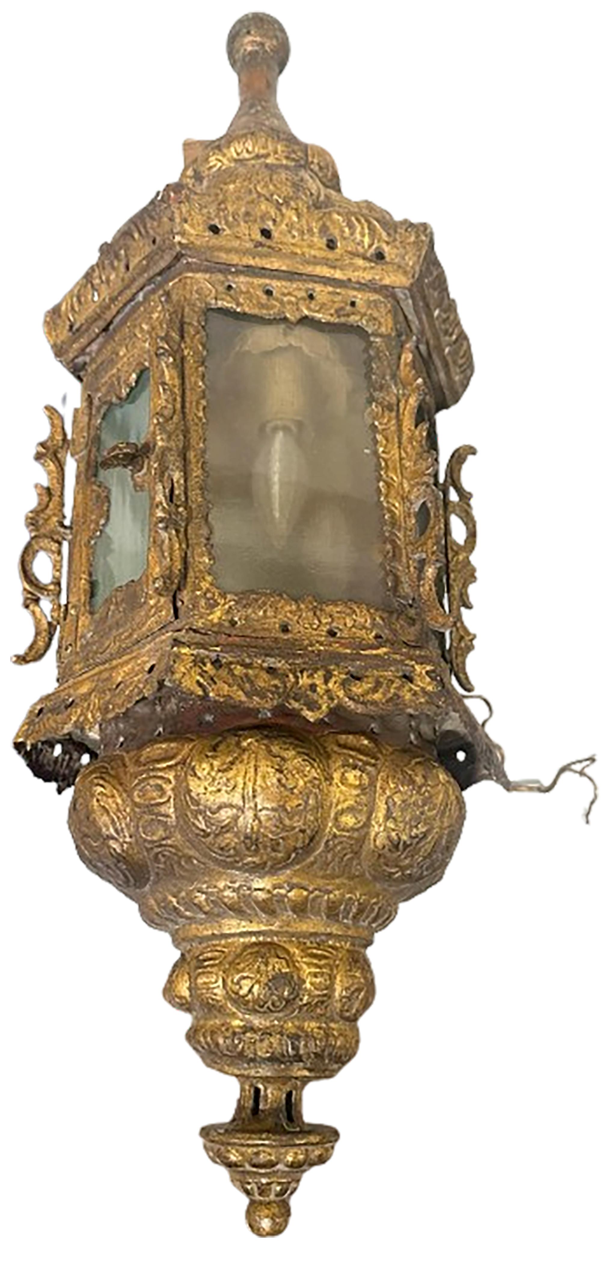 A bold near pair of electric gilt metal torch sconces.  Made between the 17th to 18th century made in Venice Italy. Light bulbs included on the inside. Hardware for wall installation included on the back. Beautifully intricate individualized