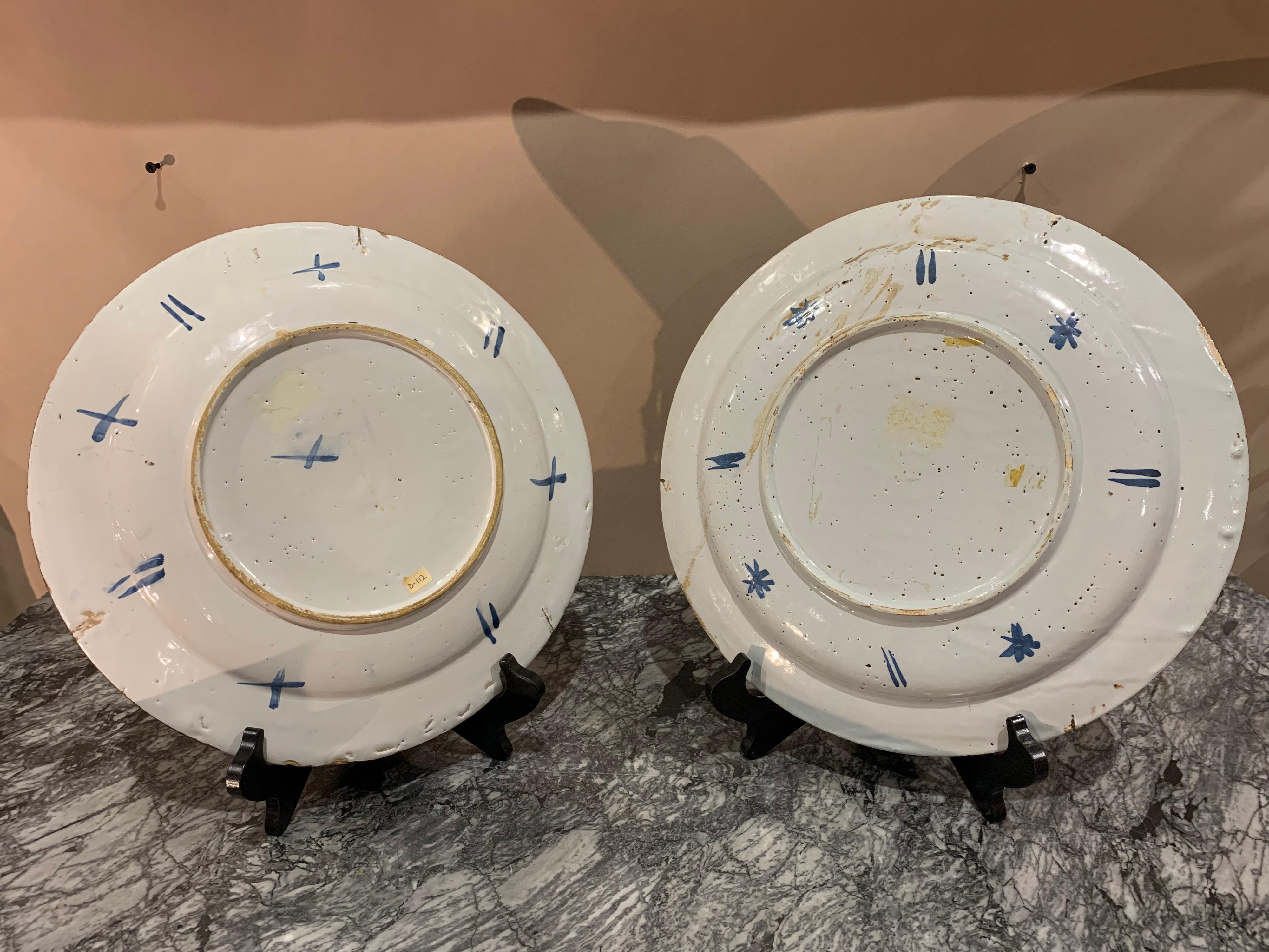 Near pair of 18th century English polychrome delft chargers- Measure: 13” diameter.