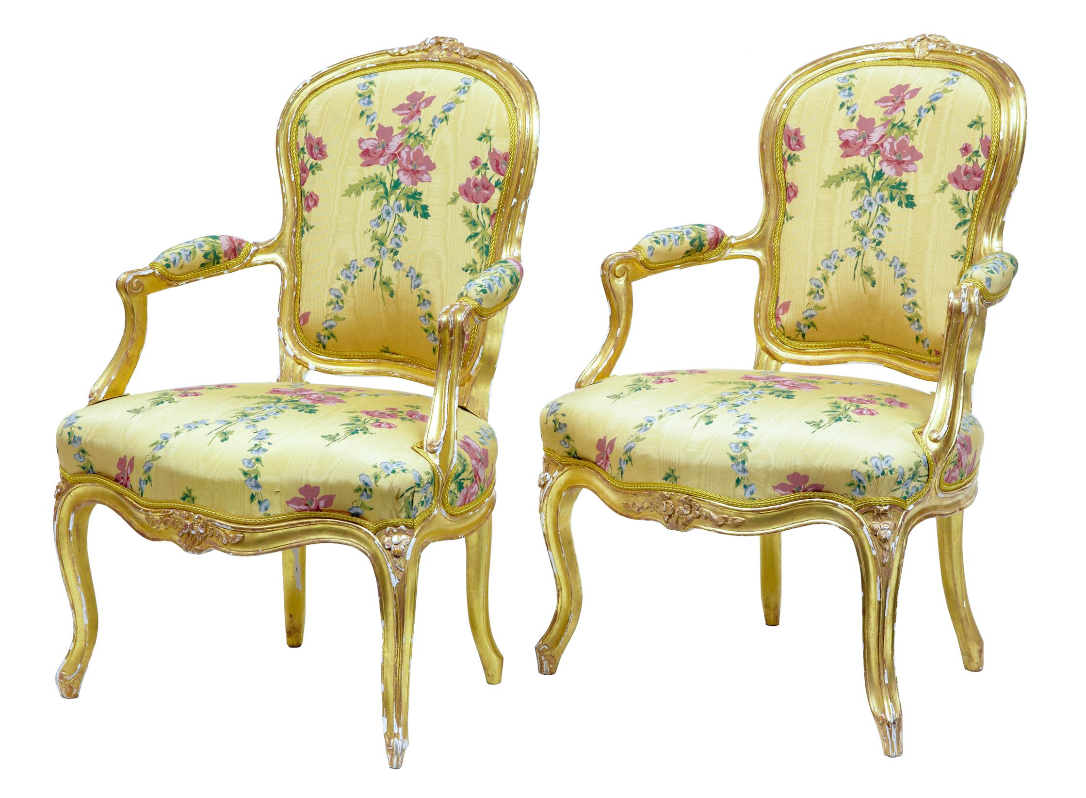 Near pair of 18th century Louis XV gilt armchairs by Michard, circa 1770.

Fine pair of Classic fauteuil armchairs. Carved shaped backs, scrolled arms, further carved detail to frieze and top of legs. 1 chair stamped 'michard'

Upholstered in