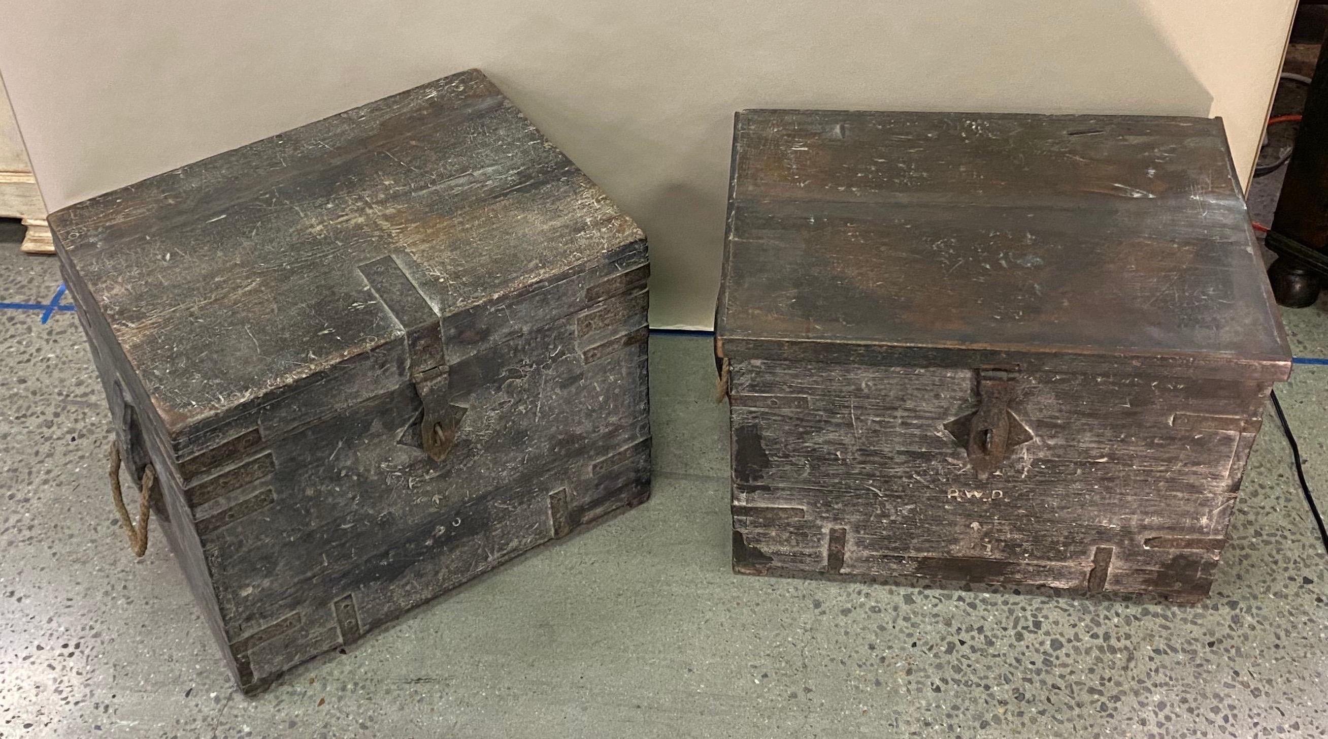 Near pair of 19th century British colonial teak munitions trunks used as side tables. About an inch difference in the two- not really noticeable unless right next to each other. Could very easily be altered to measure the same height. 

One