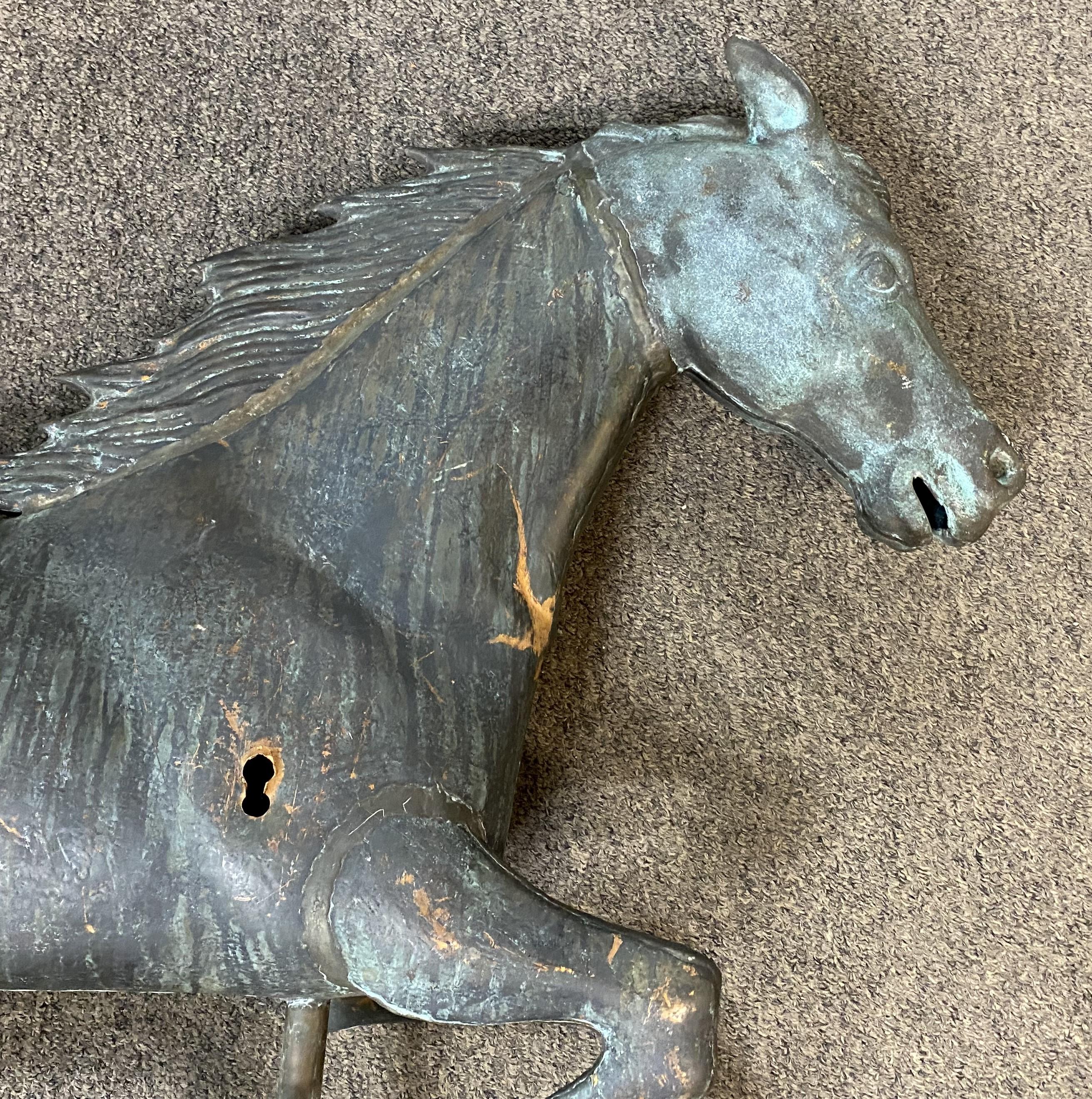 A fine near pair of copper & zinc head running horse weathervanes with great overall patina, light verdigris, and surface (bullet) holes, dating to the 20th century. Each are in very good condition, with minor imperfections, a very minor tail tip