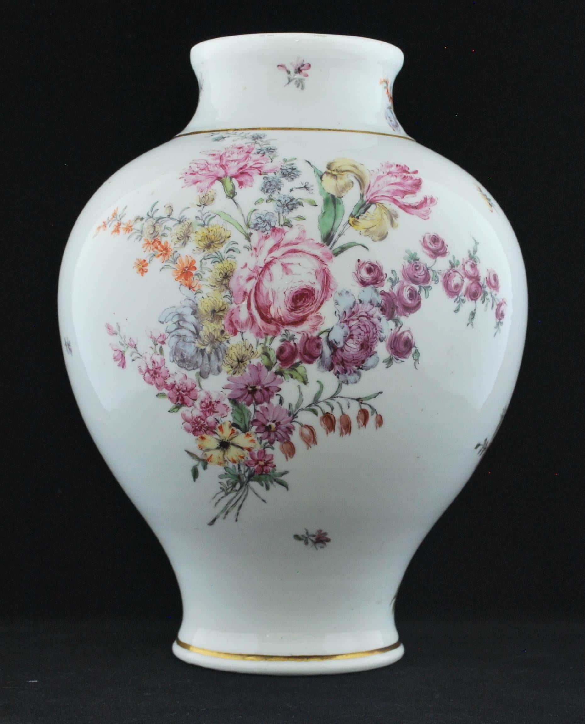 Baluster shaped vase in soft paste porcelain with early gilt line decoration. Superb flower painting.

The shapes are very close, and the gilding is slightly more elaborate on the second vase, which probably about a year later than the first, when