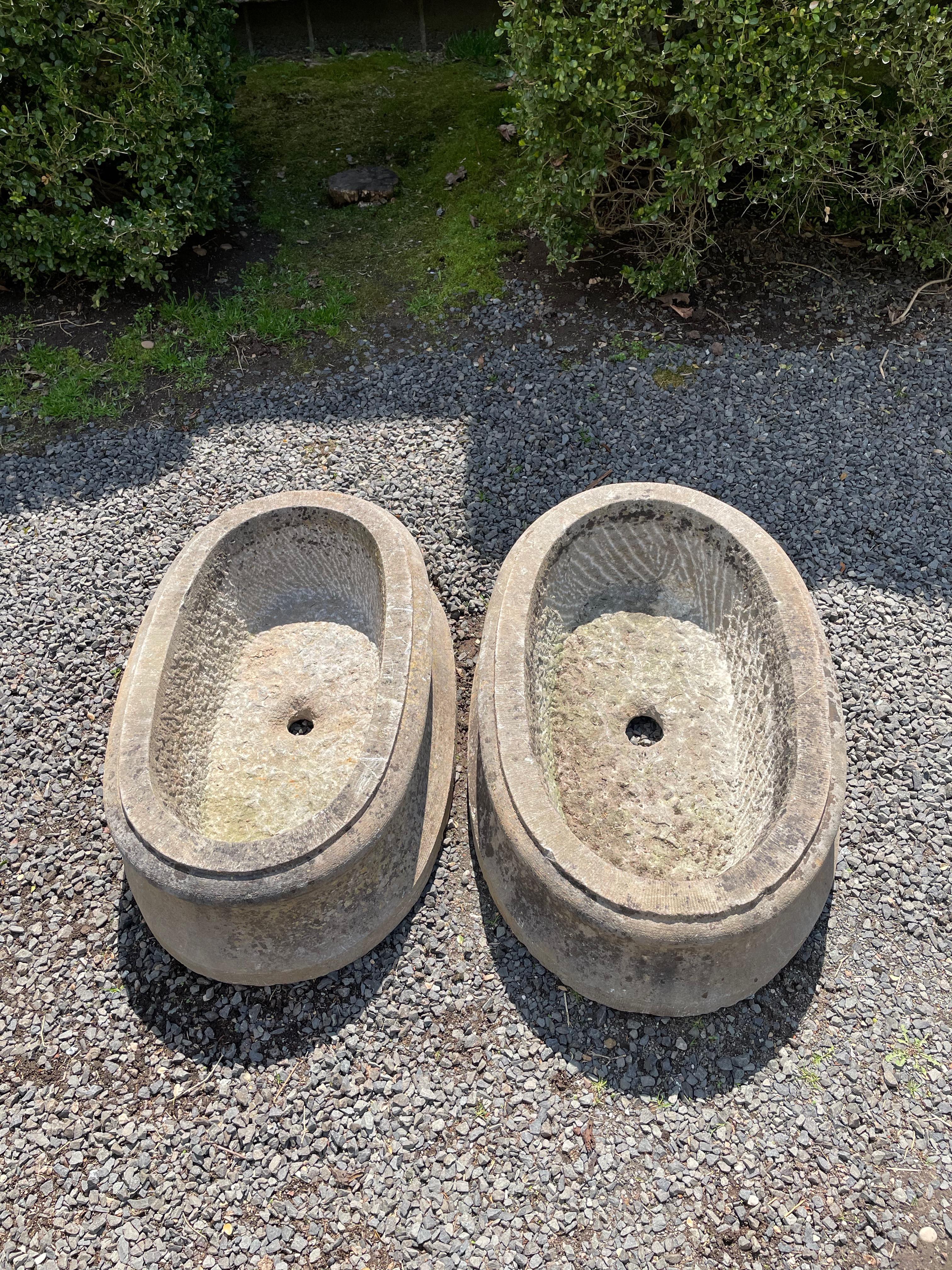 These flaring oval-shaped jardinieres were hand-carved in the early 19th C from Belgian bluestone that is extremely hard and durable. Both are in lovely antique condition and they are near-enough in size to look like a pair when planted. Elegant in