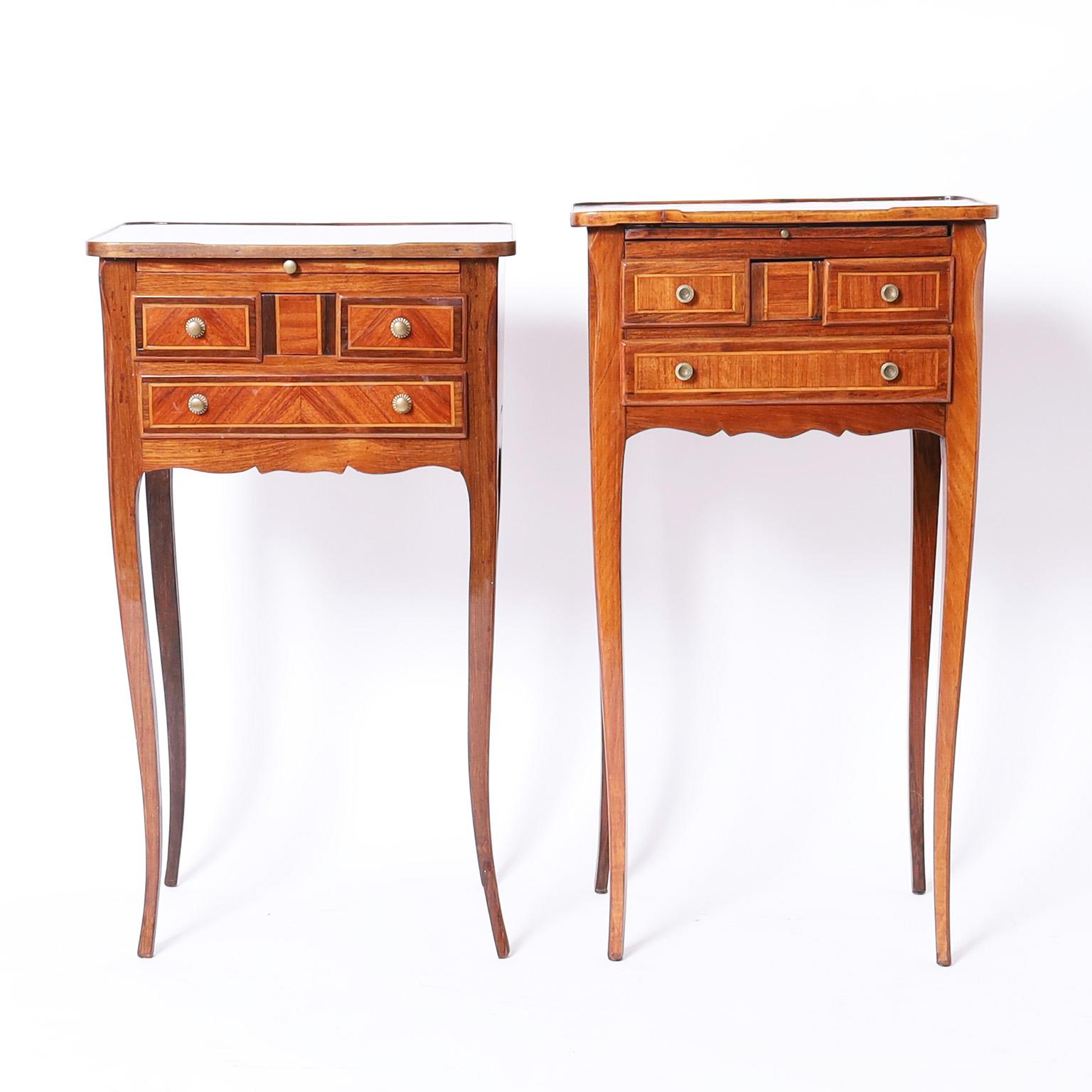 Tall elegant near pair of French stands or tables both crafted with walnut tops over three drawer cases in mahogany with cross banding and pull out trays on long graceful legs.

From left to right:

H: 29.5 W: 17 D: 12 
H: 31 W: 17 D: 12
