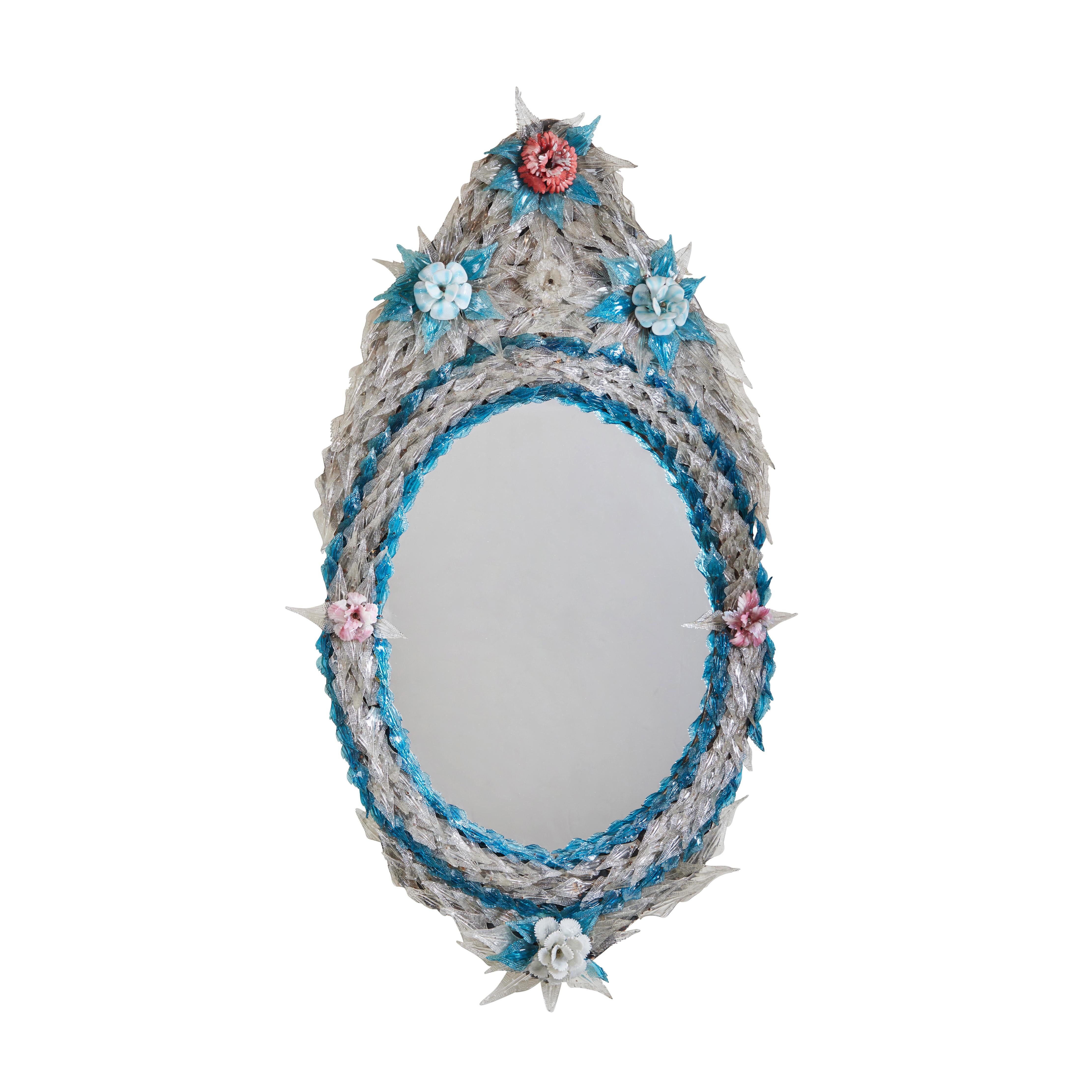 Une proche paire de miroirs ovales vénitiens recouverts de feuilles de verre, embellis de fleurs.  Peut être vendu séparément.