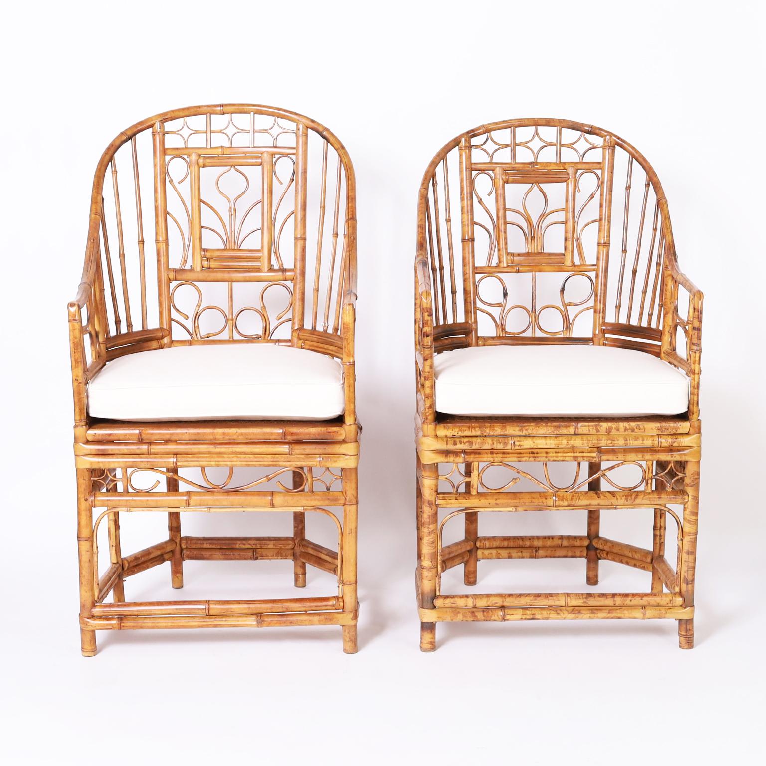 In vogue near pair of Brighton Pavilion style chairs handcrafted in bamboo in the iconic Chippendale form with caned seats.

Left: H: 43 W: 22 D: 20 Seat: 22
Right: H: 41.5 W: 22 D: 20 Seat: 22