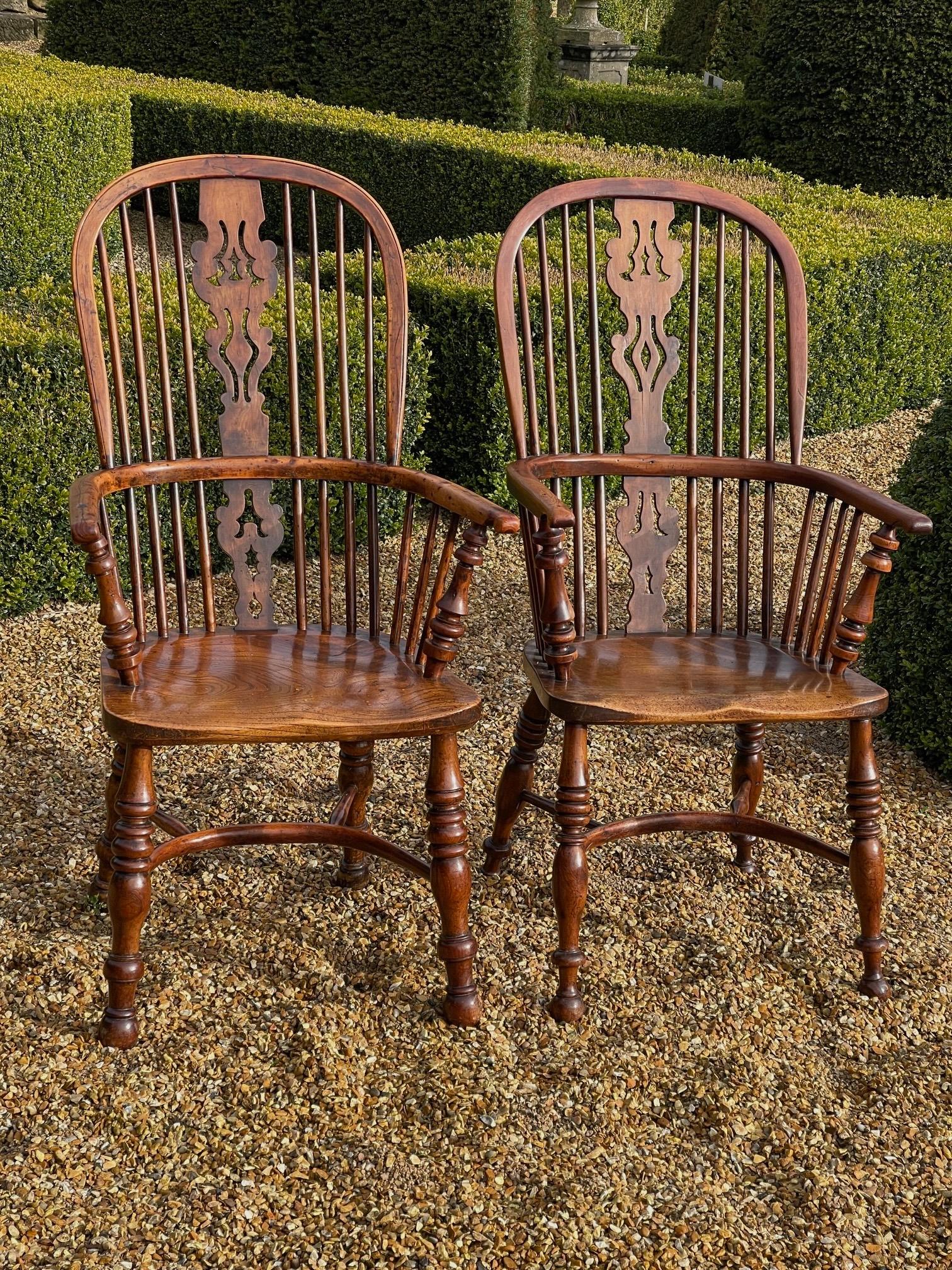 Near pair of yew wood Windsor chairs with crinoline stretchers and interesting splats 

size 110cms high width across arms 58cms seat 47cms 