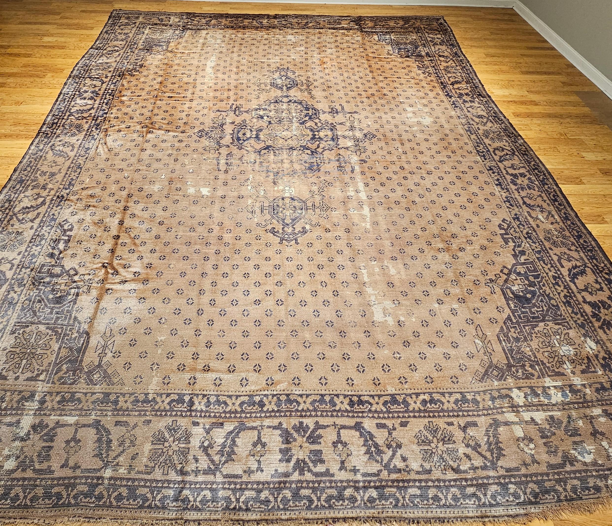 Esta alfombra turca Oushak vintage de principios del siglo XX, casi cuadrada y de gran tamaño, es un raro tesoro para coleccionistas y diseñadores por igual, y un notable ejemplo del arte de tejer de Anatolia. Buscada tanto por sus equilibradas