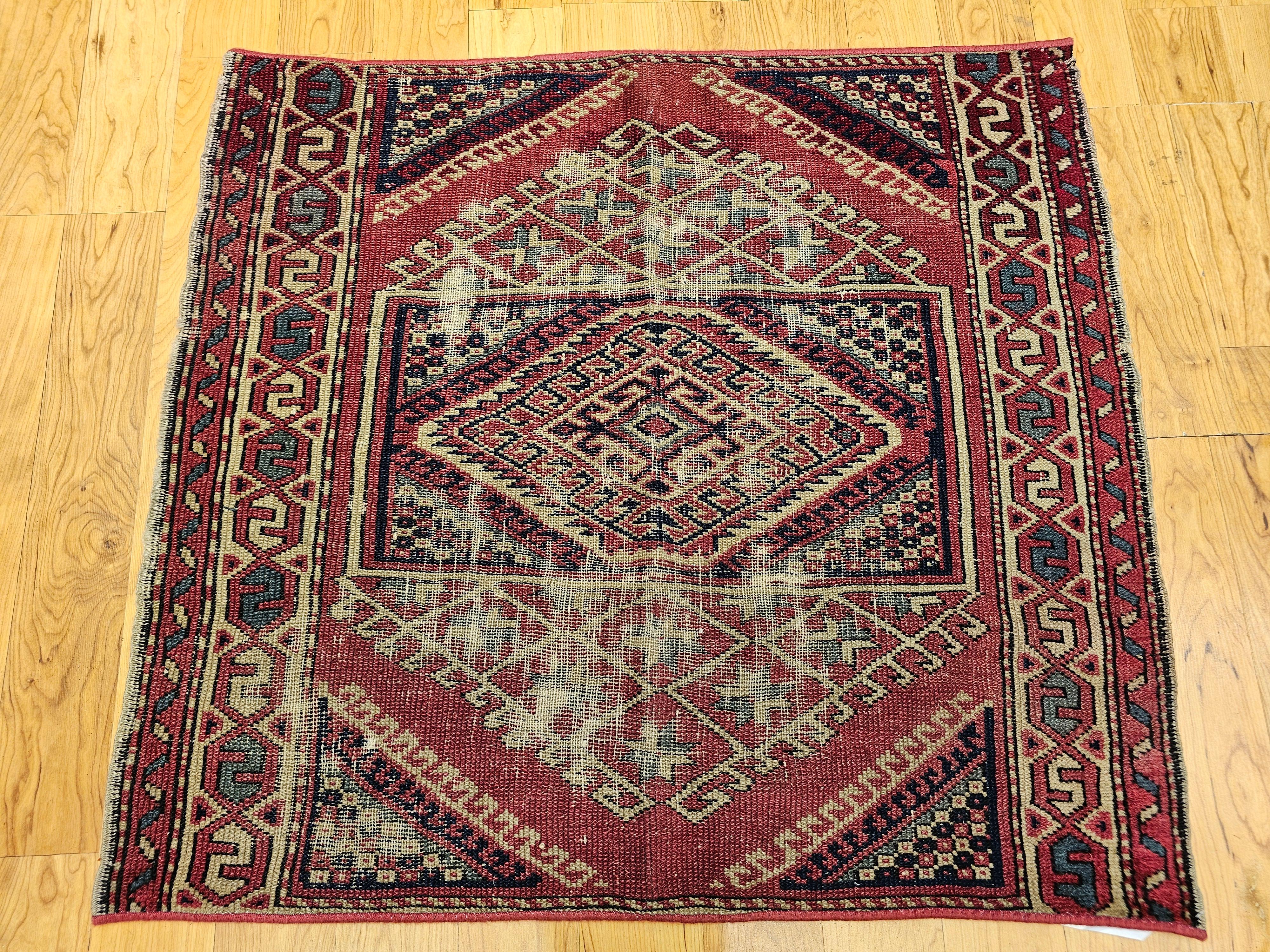 This near-square antique Turkish Village rug is a striking example of Anatolian craftsmanship, showcasing a bold geometric pattern reminiscent of Caucasian prayer rugs. Handwoven with wool on a wool foundation and dyed using natural pigments, it